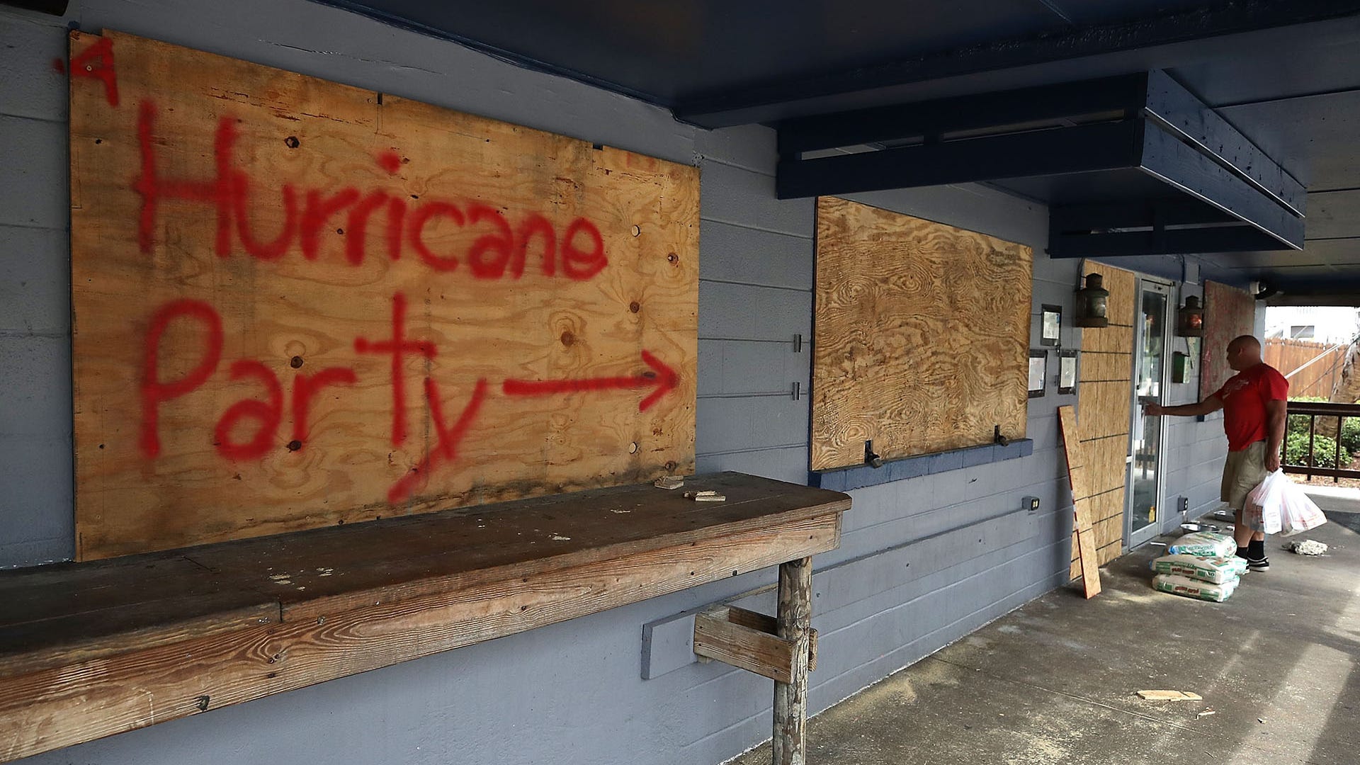'Hurricane Party' written on plywood covering the window of the Lager Heads Tavern in Wrightsville Beach, North Carolina, Tuesday