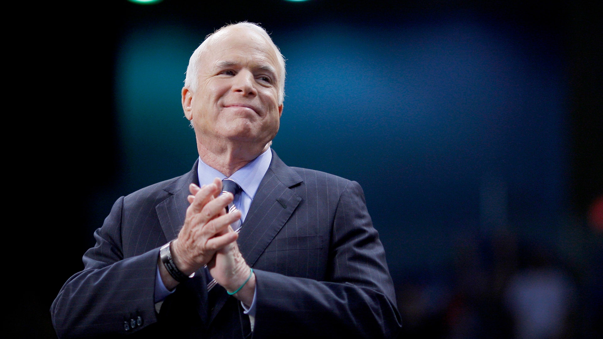 U.S. Republican presidential nominee Senator John McCain listens as he is introduced at a campaign rally in 2008