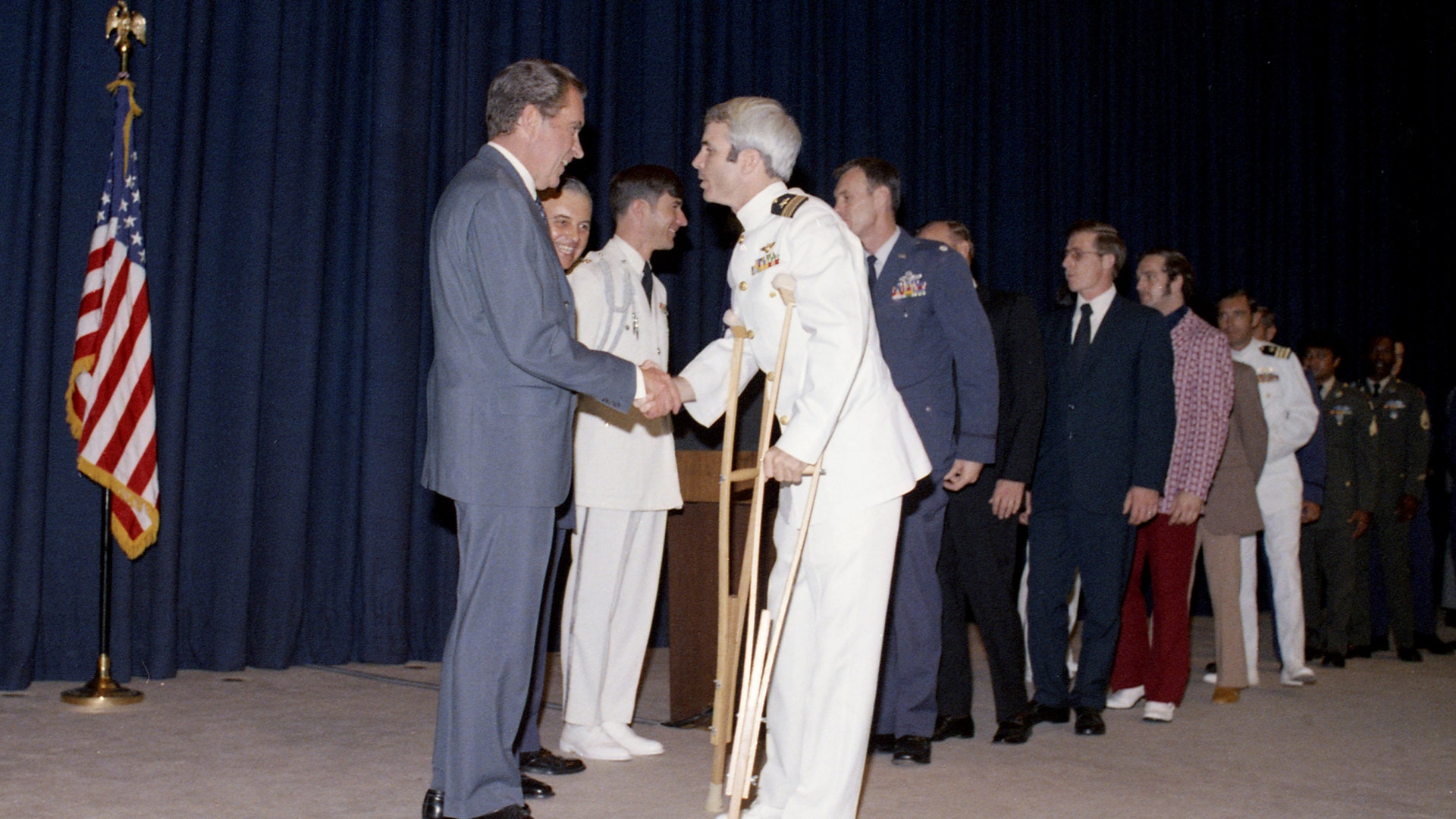 U.S. President Richard Nixon greets former Vietnam prisoner of war John McCain at a pre-POW dinner reception