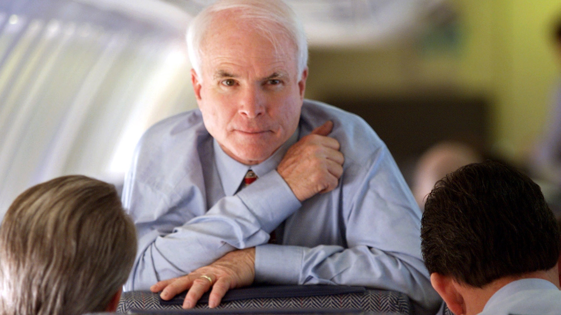 Republican presidenital hopeful John McCain looks up while speaking with his campaign manager Rick Davis