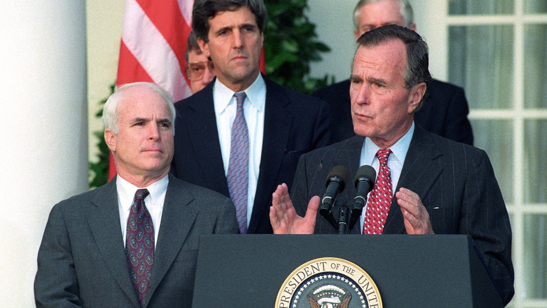 President George Bush addresses reporters at the White House with Senator John McCain (L) and Senator John Kerry