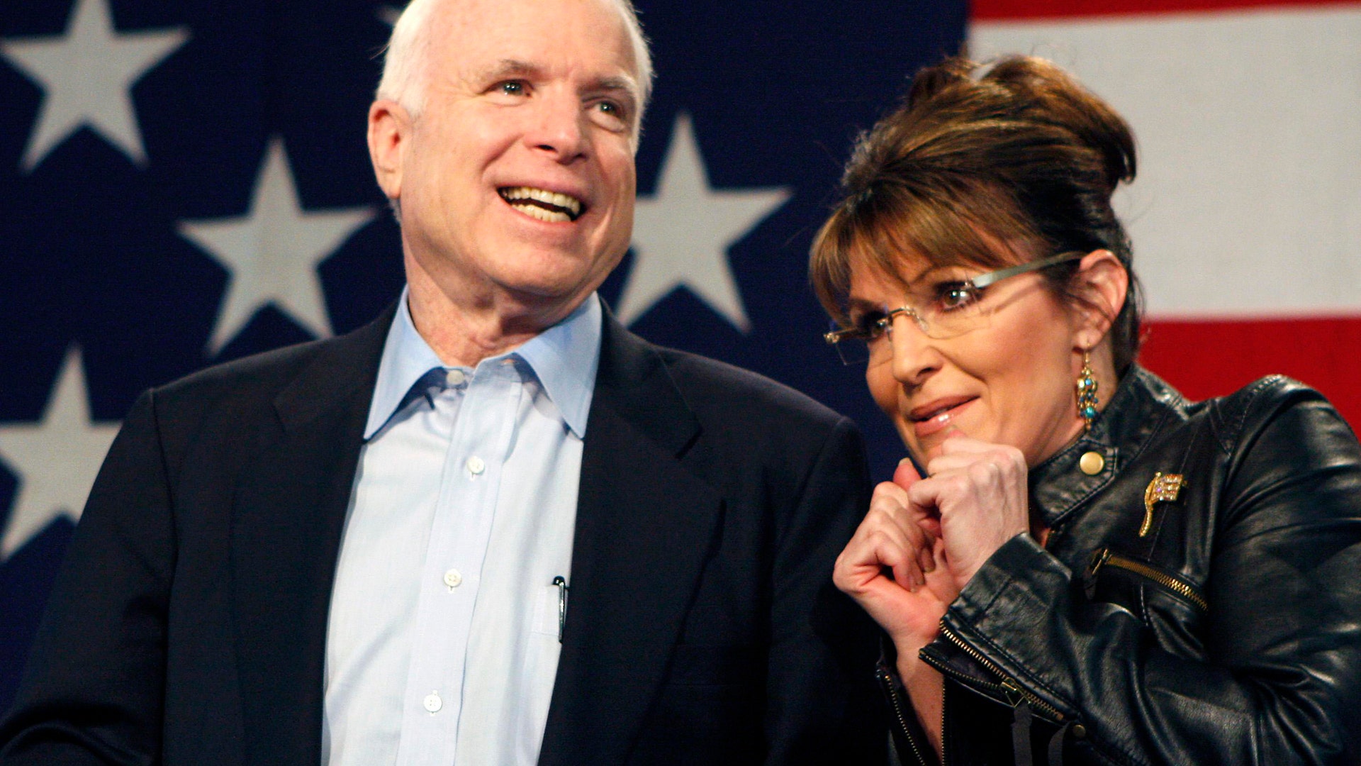 Senator John McCain and former Alaska Governor and VP candidate Sarah Palin acknowledge the crowd during a rally