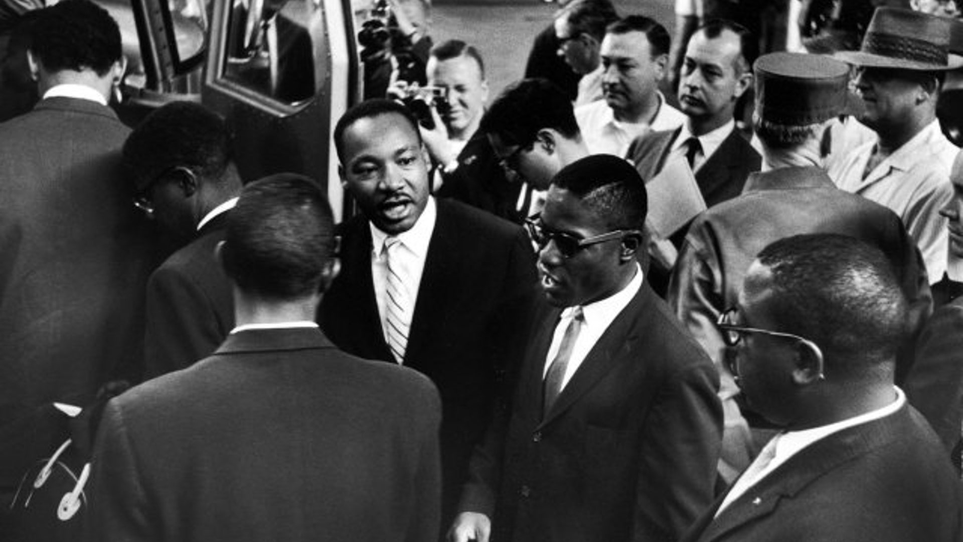 Martin Luther King Jr. encourages freedom riders as they board a bus for Jackson, Miss., 1961.