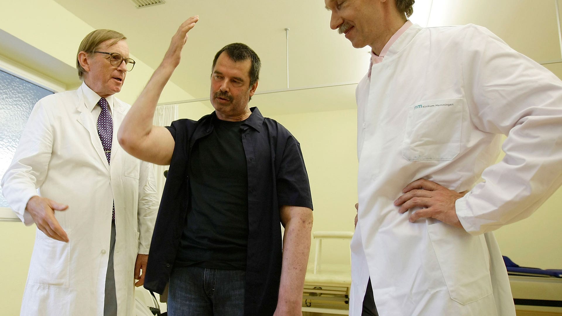 Merk Stands With Arm Raised