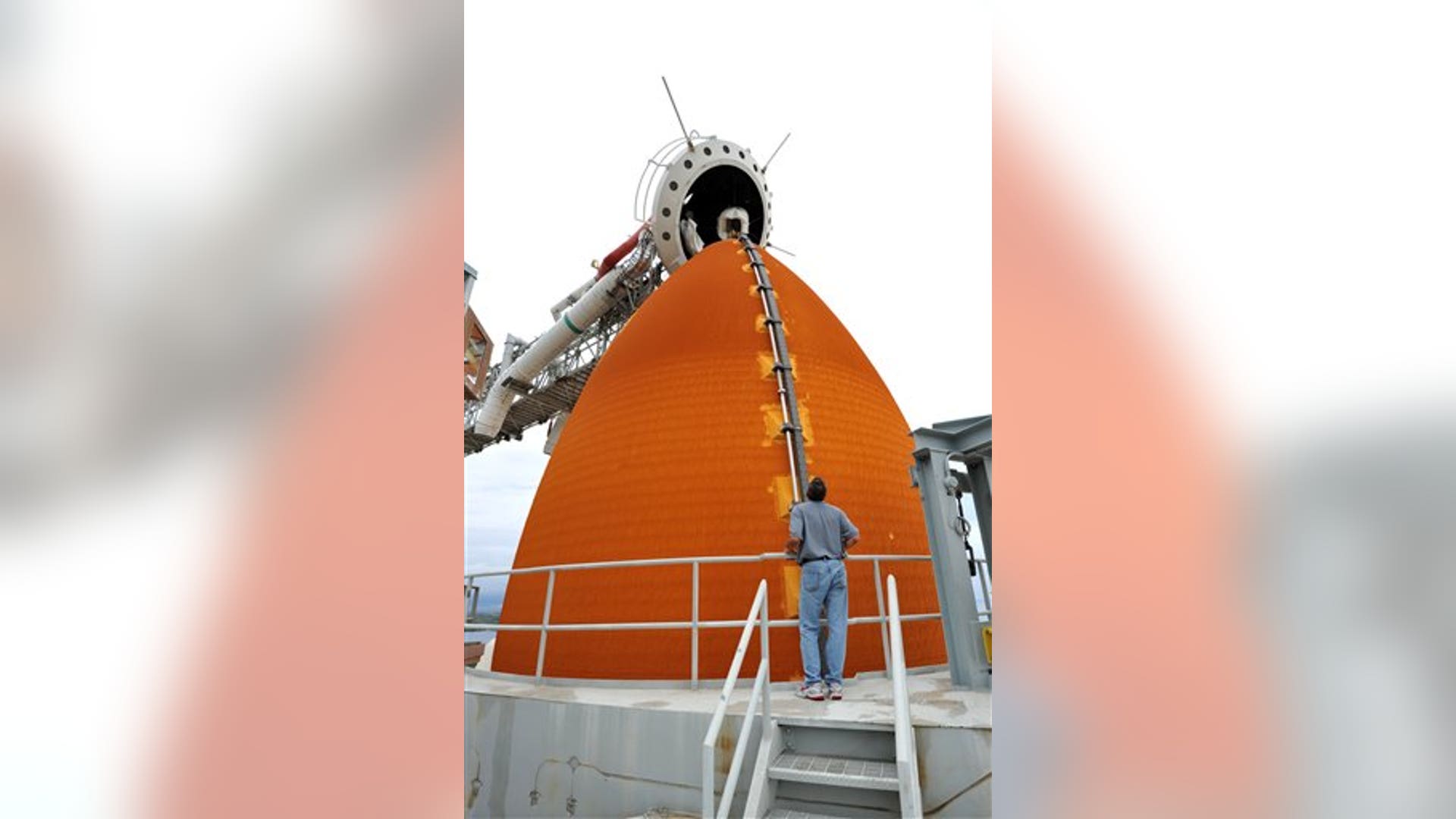 NASA worker near Atlantis' solid rocket booster