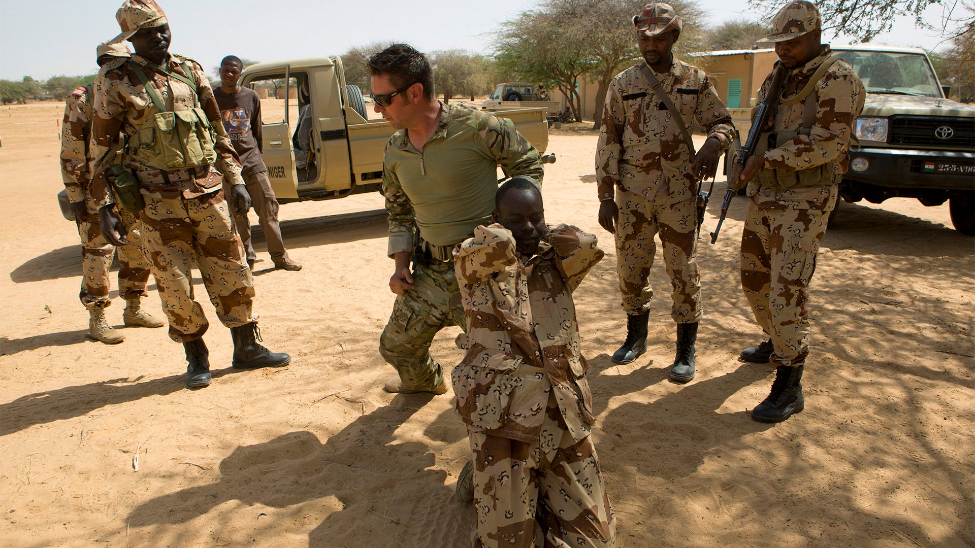 A U.S. special forces soldier demonstrates how to detain a suspect during a training mission for African militaries,