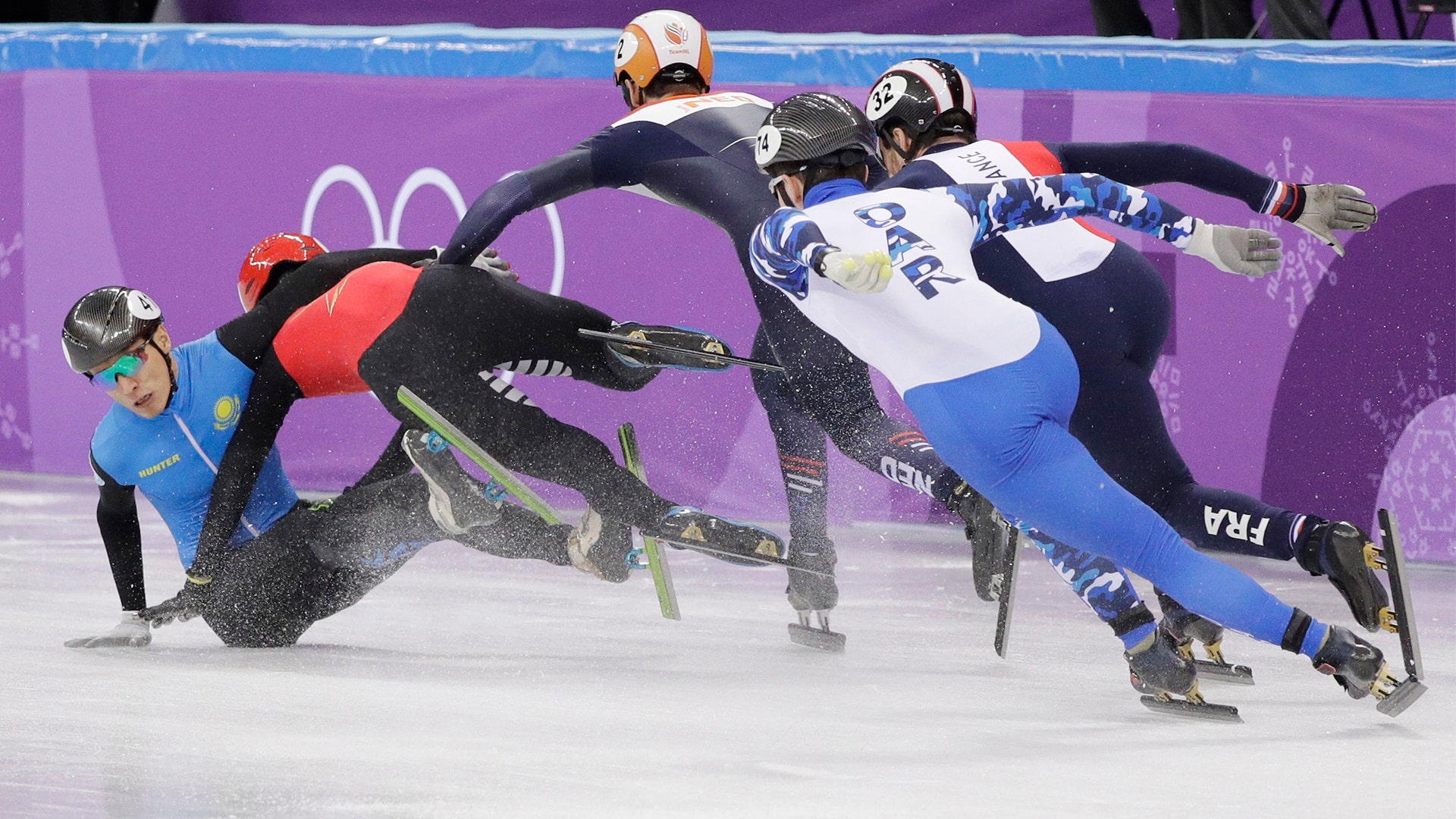 Nurbergen ZhNumagaziyev of Kazakhstan and Hongzhi Xu of China crash out during the 1500 meters short-track speedskating
