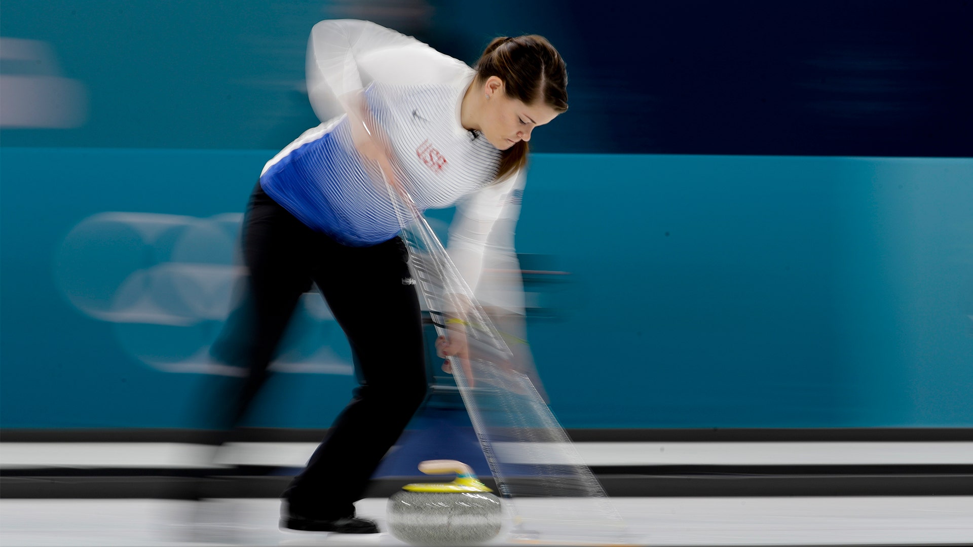 United States Becca Hamilton sweeps the ice during a mixed doubles curling match against Norway