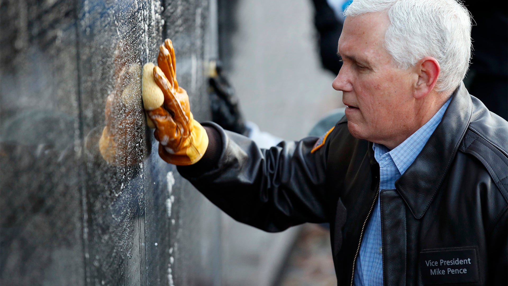 Vice President Mike Pence cleans a portion of the Vietnam Veterans Memorial on Veterans Day