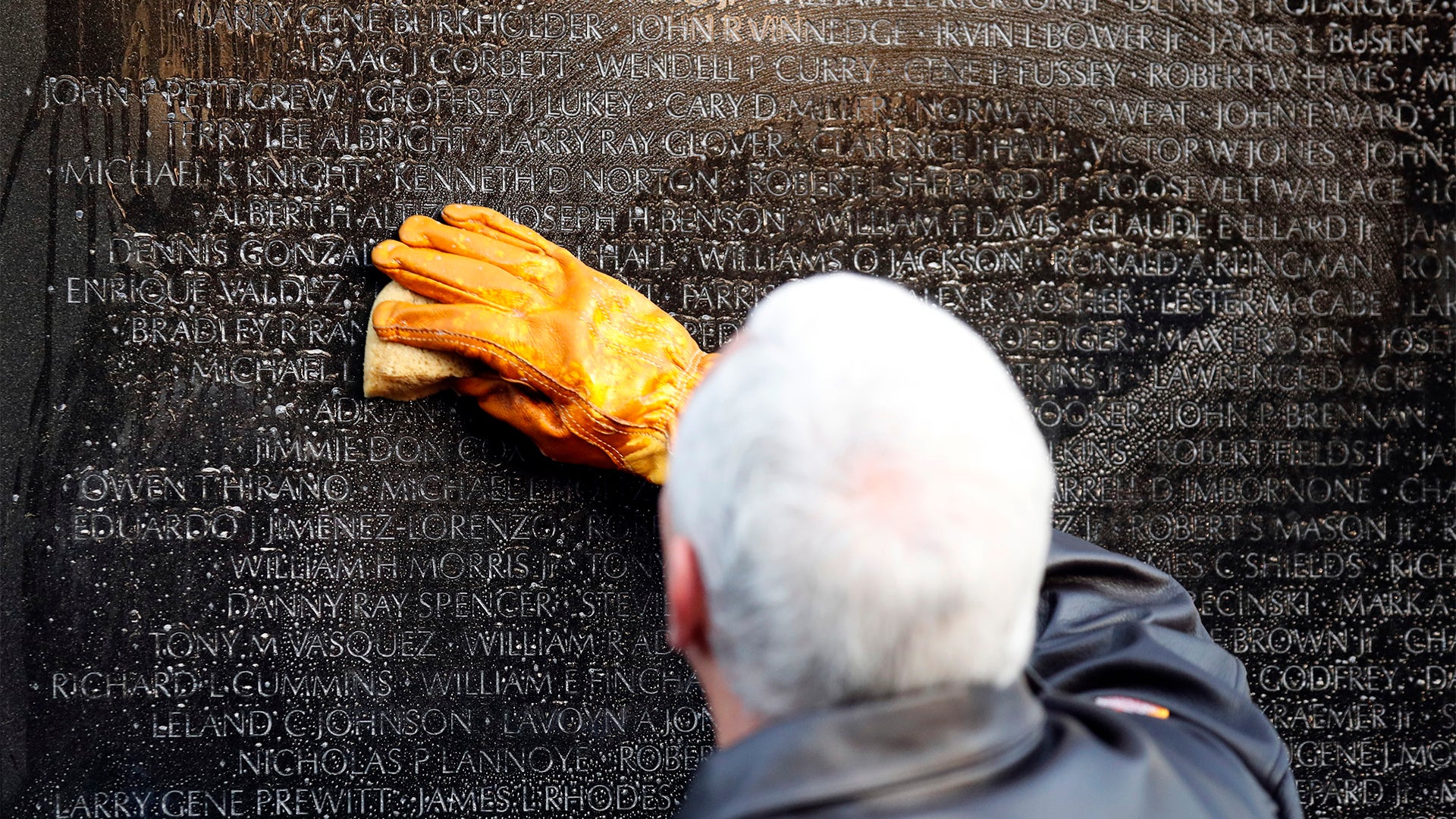 Vice President Mike Pence cleans the names of Vietnam vets at the Vietnam Veterans Memorial on Veterans Day.