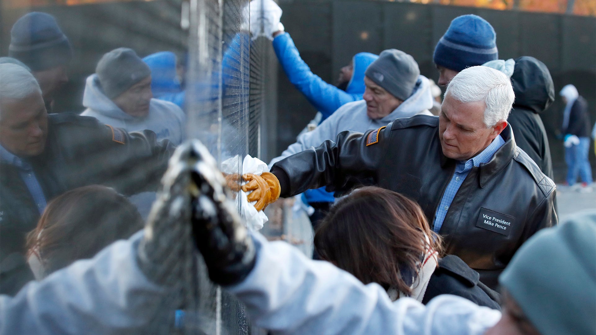 VP Mike Pence and wife Karen, with Interior Secretary Ryan Zinke, clean the wall at the Vietnam Veterans Memorial on Veterans Day