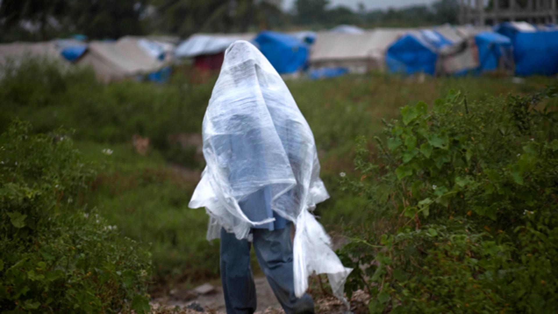 Man Uses Plastic Sheet for Rain Coverage