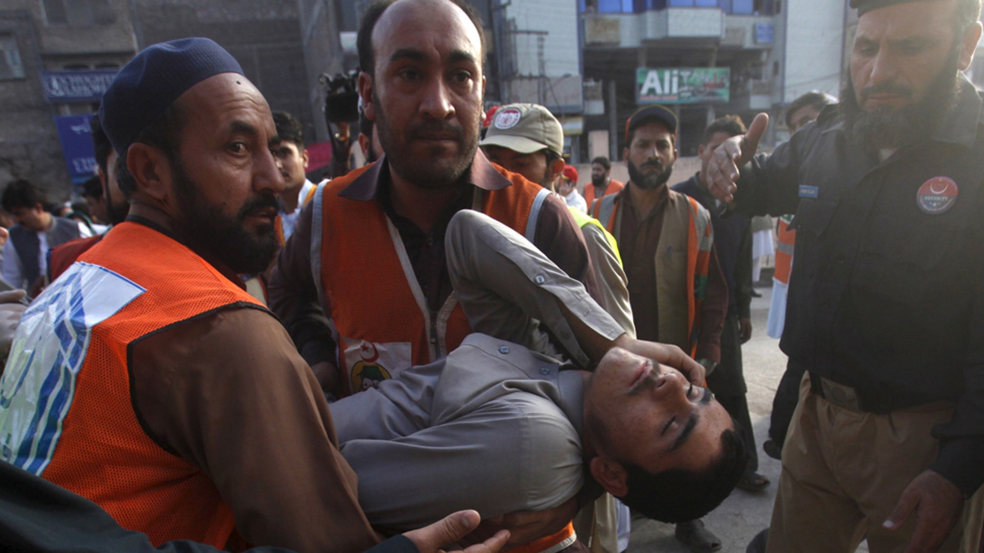 Rescue workers carry a man at a hospital