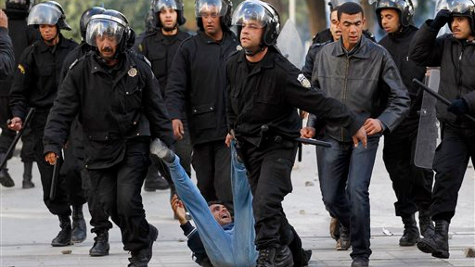 Riot_police_officers_detain_a_protestor