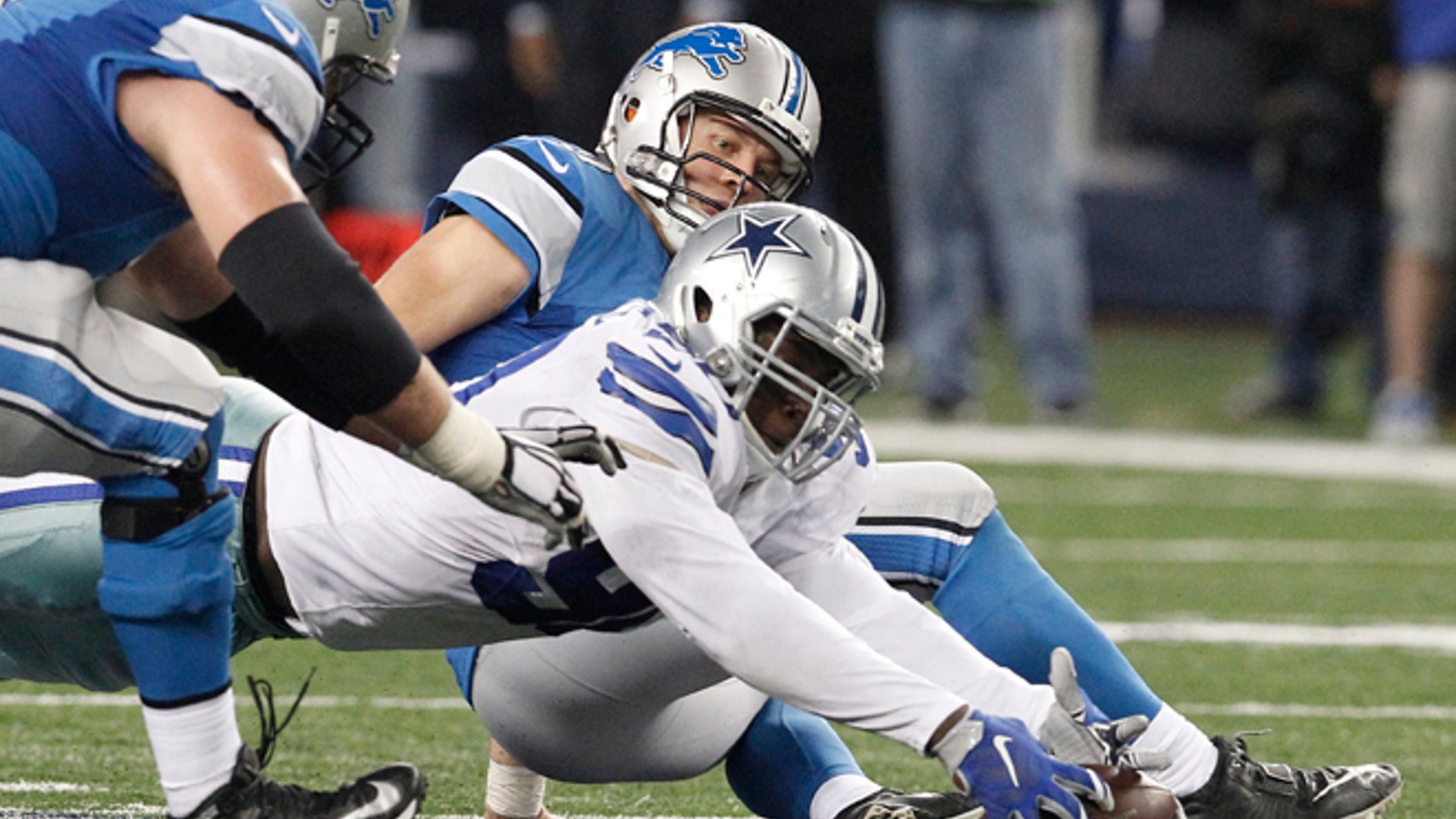 Dallas Cowboys defensive end Demarcus Lawrence recovers the ball after sacking Detroit Lions quarterback Matthew Stafford causing a fumble