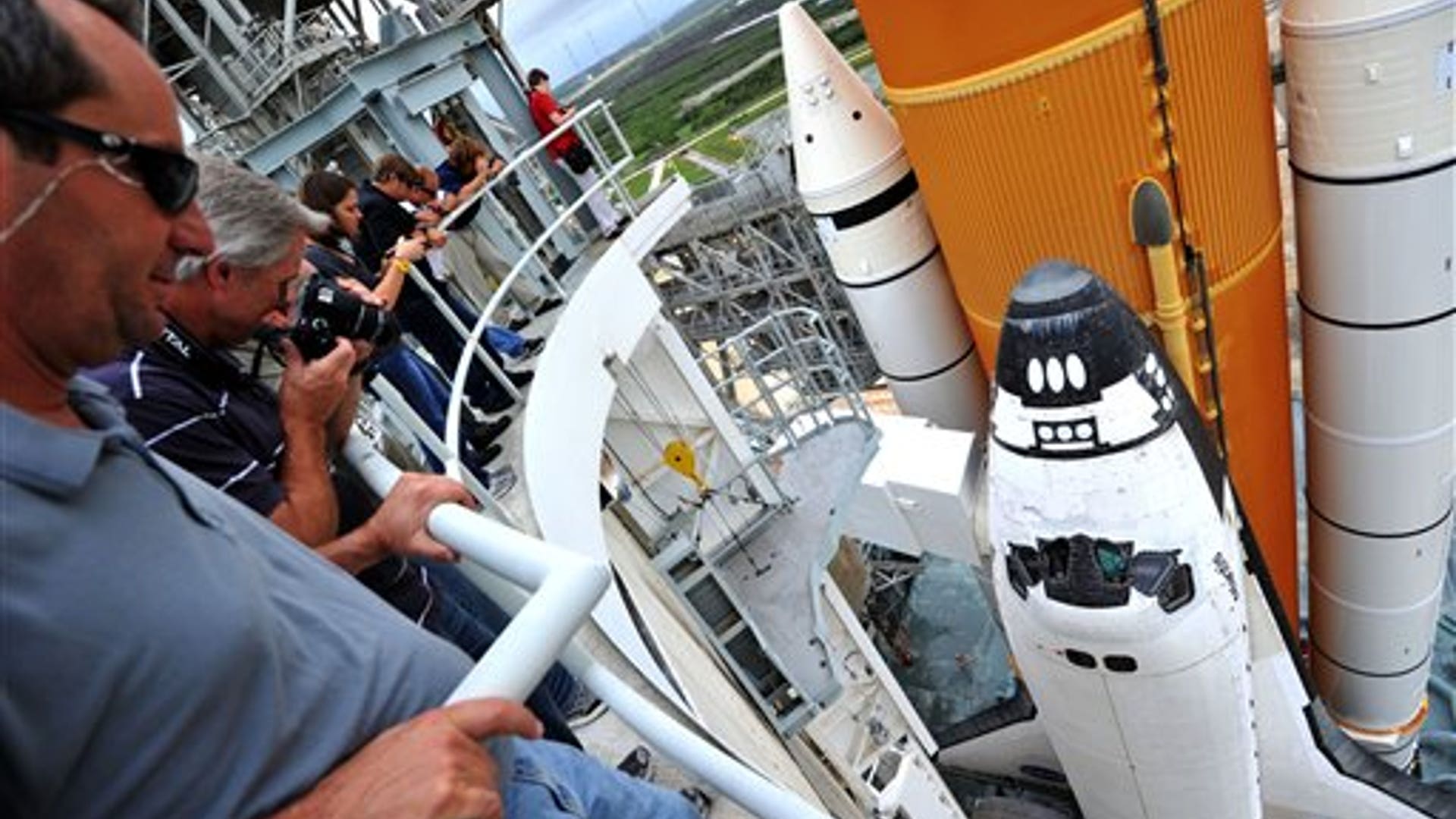 Spectators_watch_as_the_rotating_service_structure_rolls_away