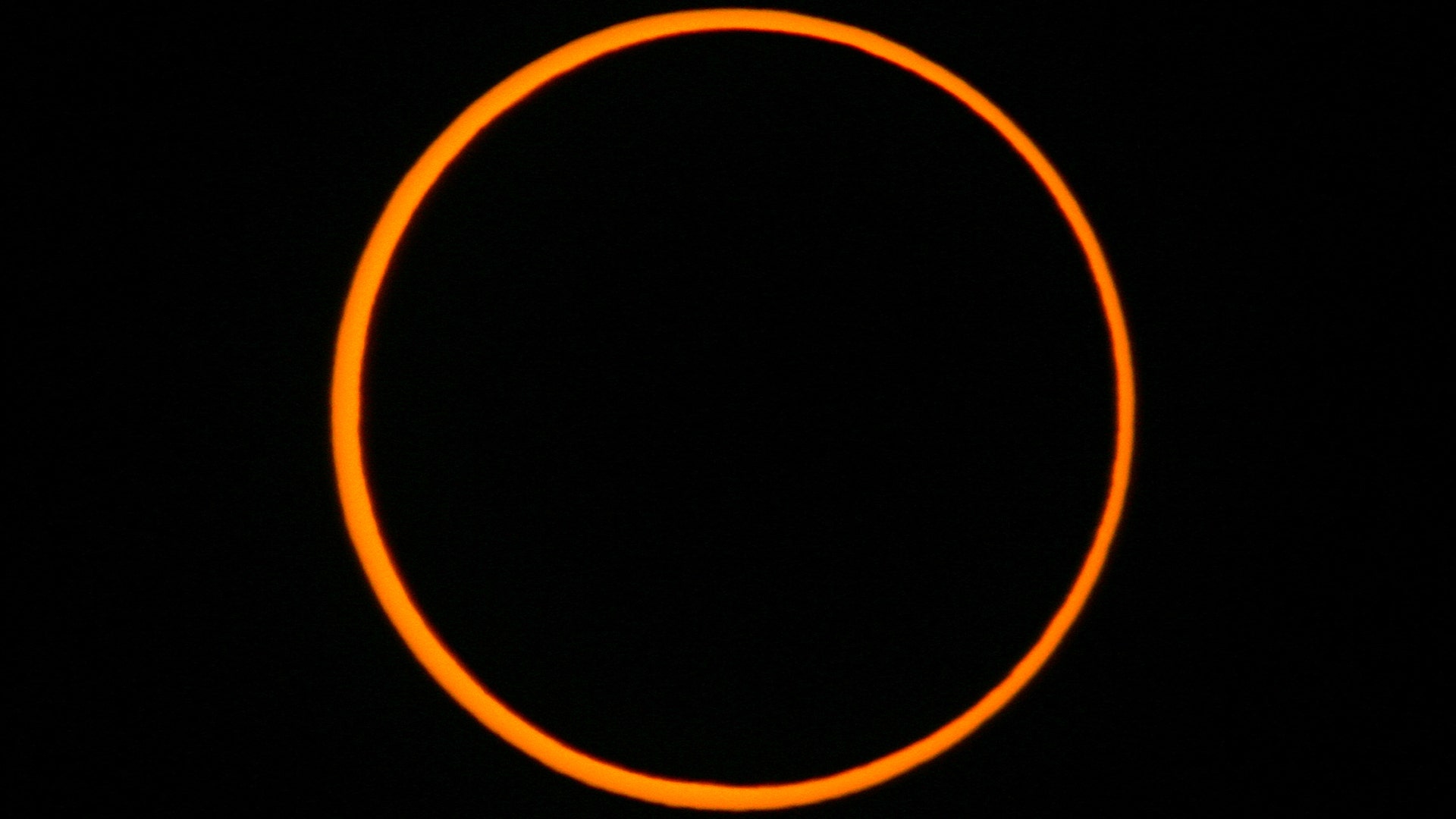 The moon passes between the earth and the sun to cause an annular solar eclipse as seen from Segovia, Spain October 3, 2005