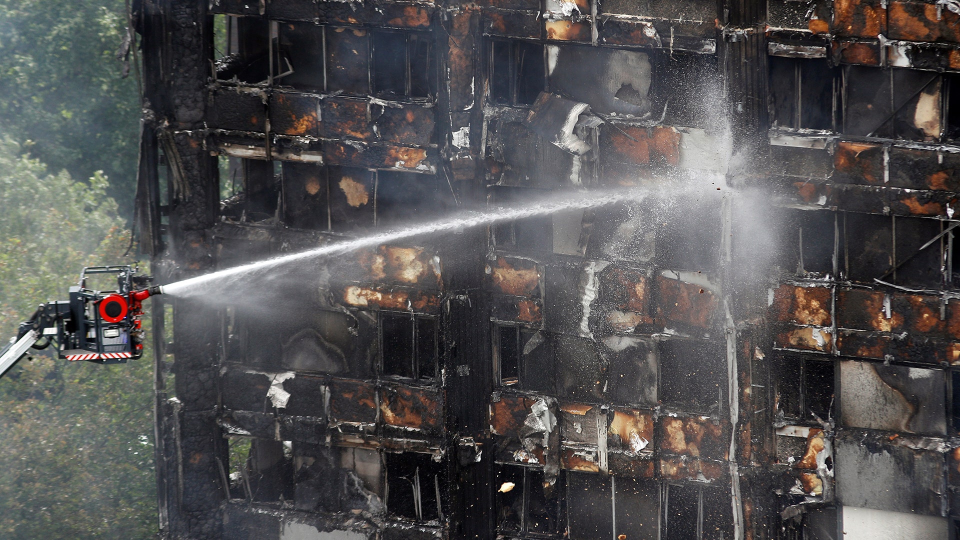 Water continues to be sprayed onto the apartment building that was destroyed in a fire in London