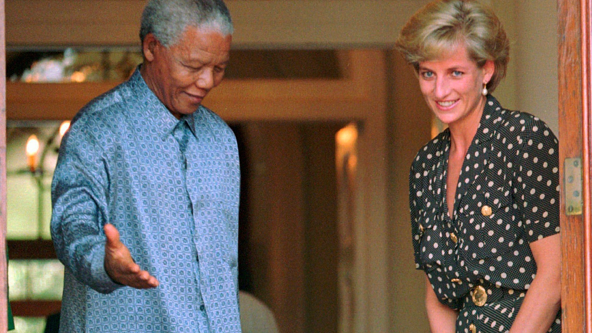 South African President Nelson Mandela shows the way to Princess Diana during a meeting in Cape Town, March 17, 1997