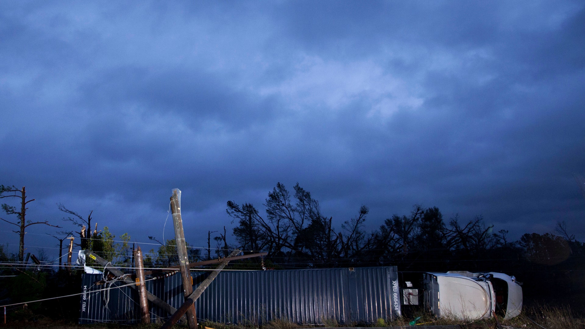 A tractor trailer truck that was damaged by an apparent tornado lays on its side, Monday, Jan. 23, 2017, in Albany, Ga. 