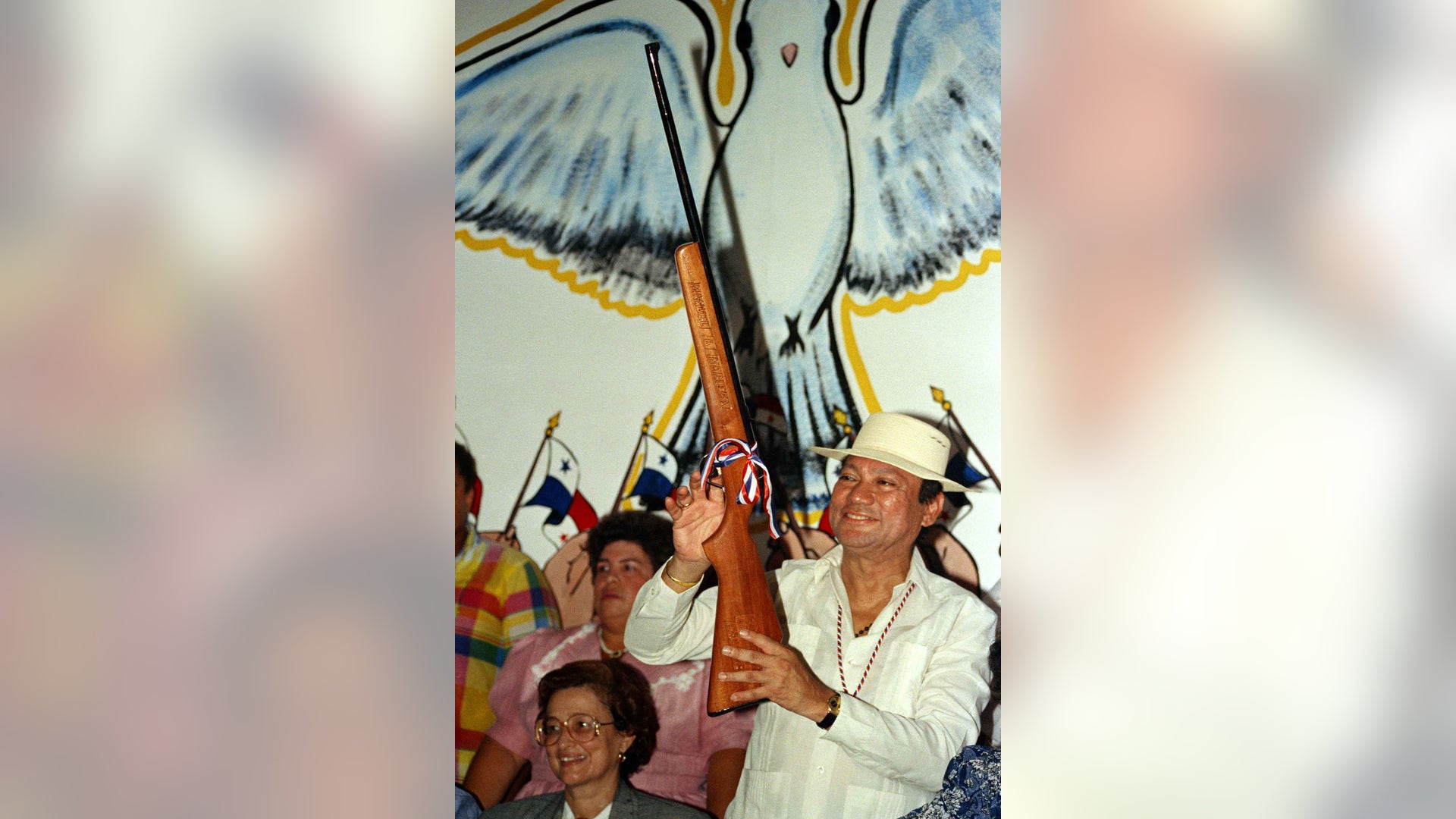 In this Oct. 5, 1989 file photo, Gen. Manuel Noriega holds a rifle bearing his name, given to him by a supporter during a pro-government rally, in Santiago, Panama.
