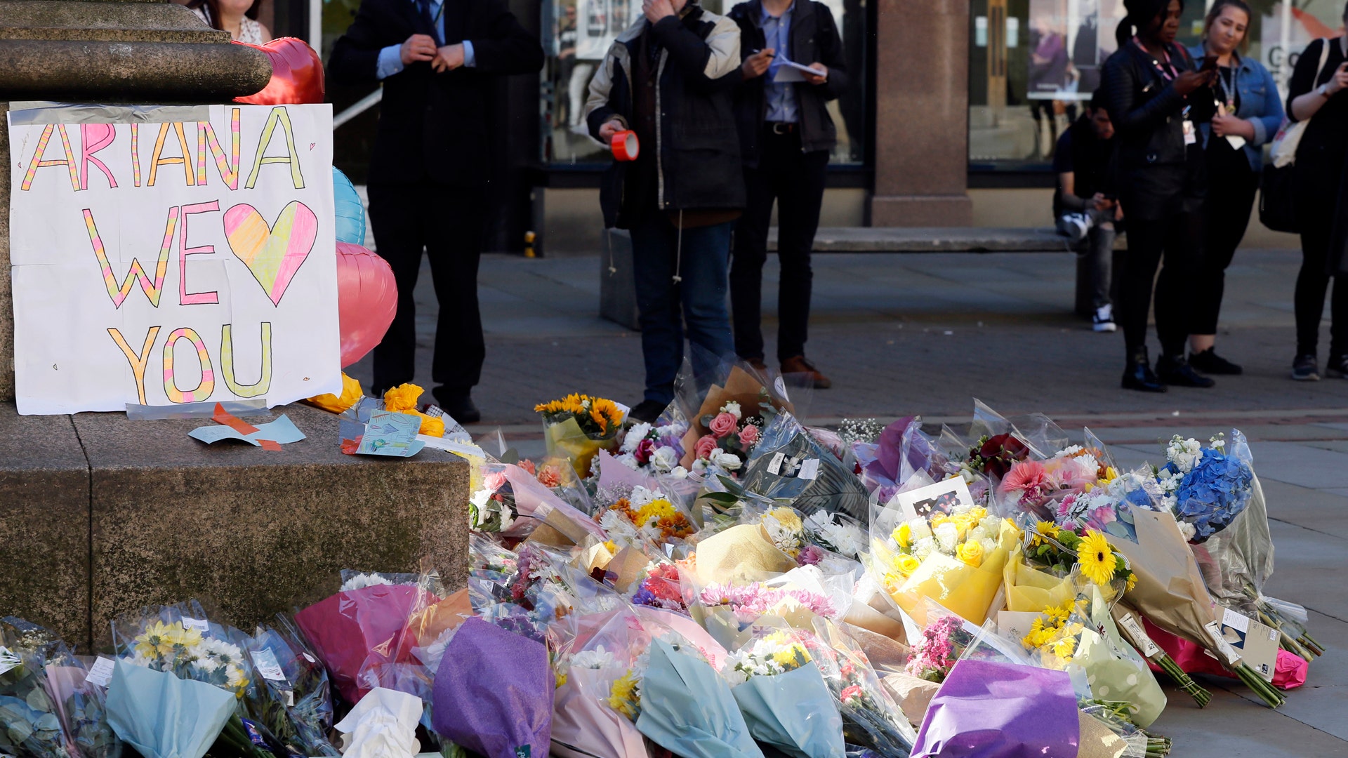 Floral tributes are seen in Manchester, England, the day after the suicide attack at an Ariana Grande concert
