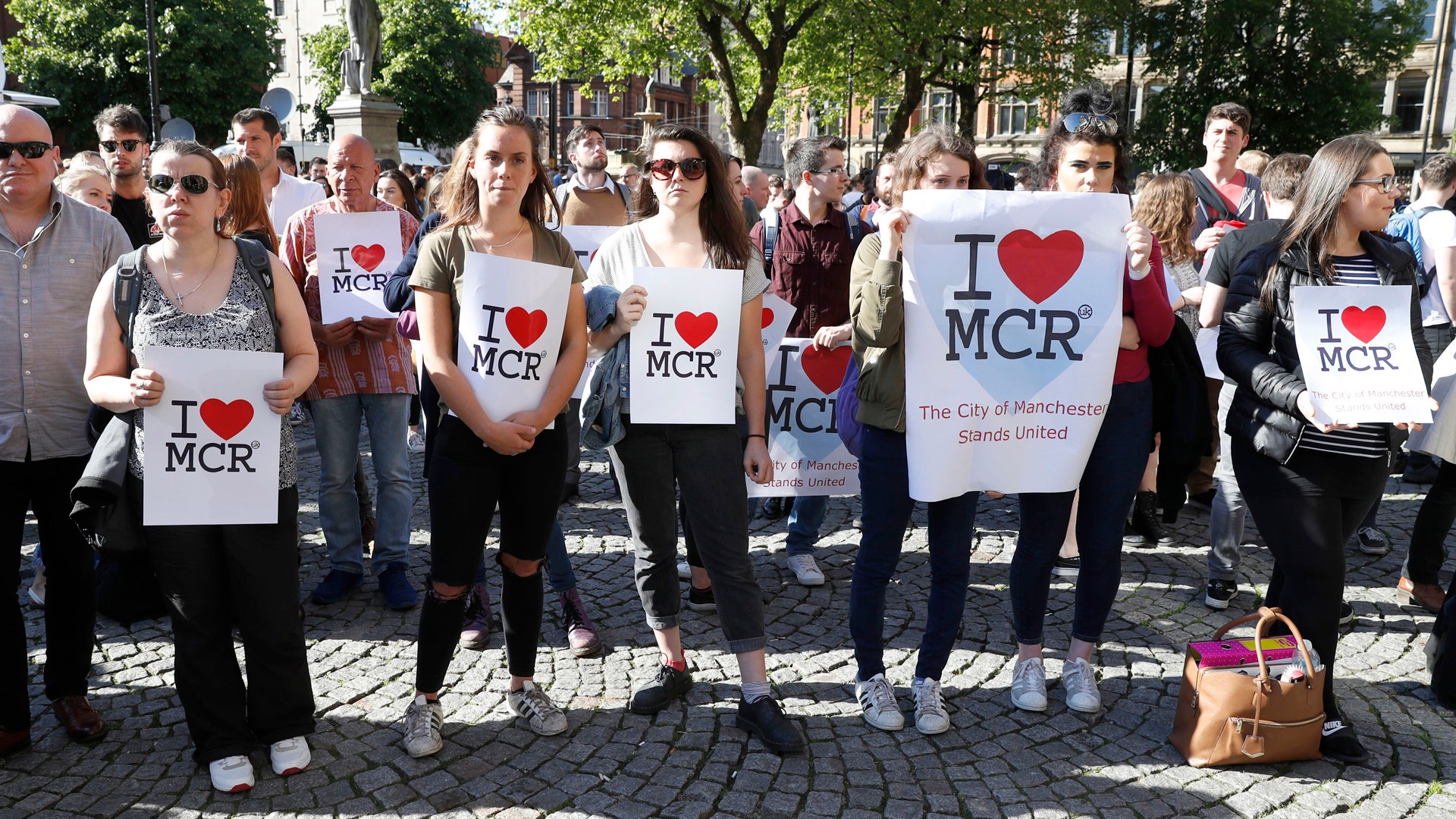 People gather ahead of a vigil in Albert Square, Manchester, England, Tuesday May 23, 2017
