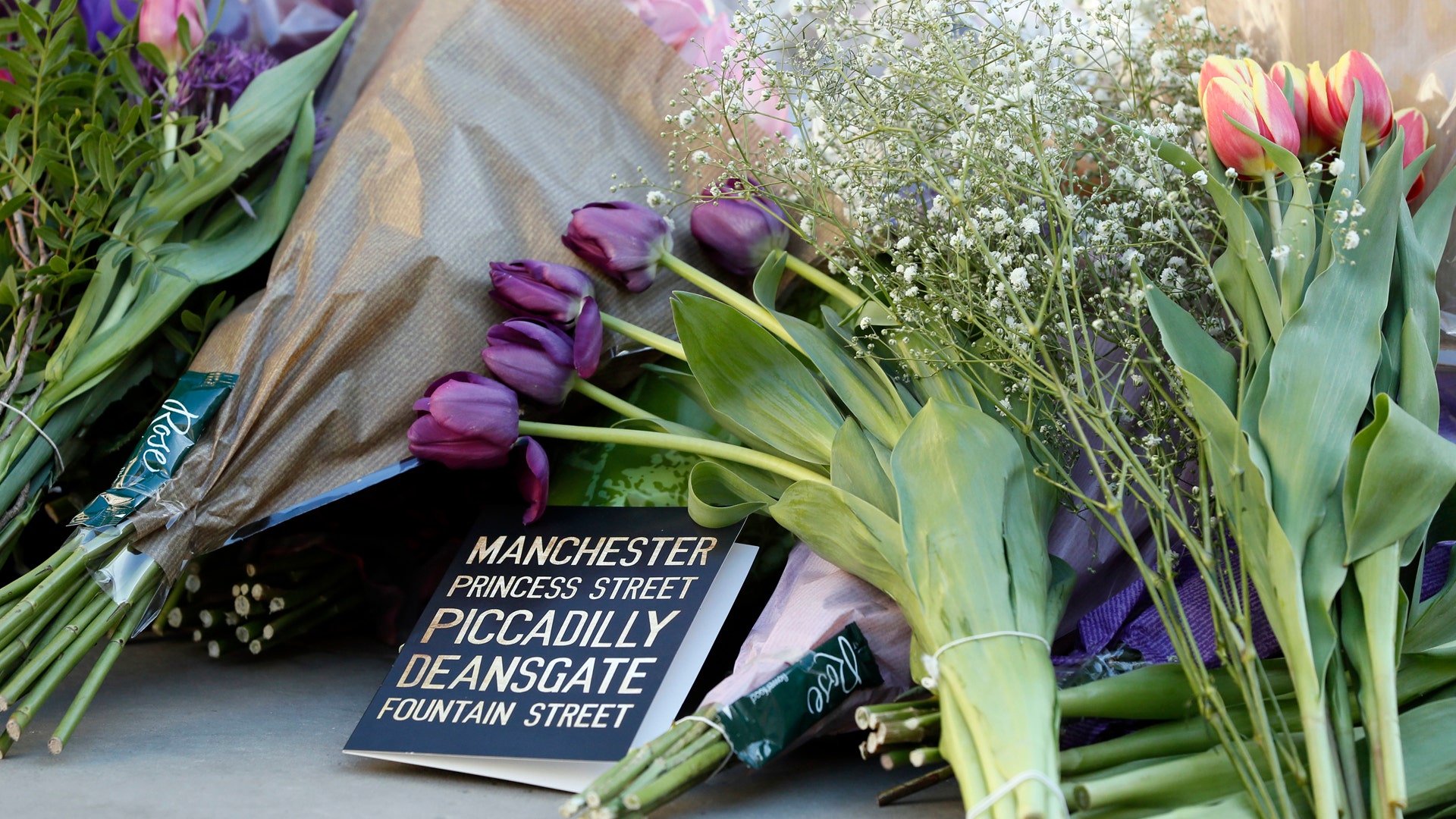 Floral tributes are laid out in Manchester, England, Tuesday May 23, 2017