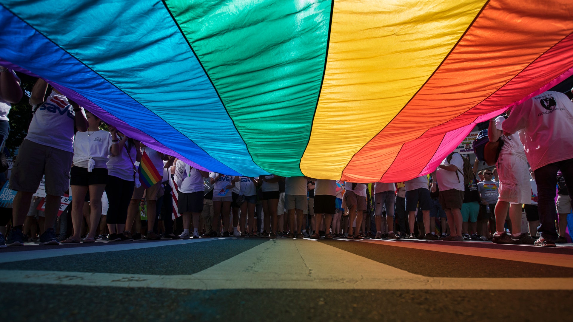 Marchers unfurl a huge rainbow flag as they prepare to march in the Equality March for Unity and Pride in Washington