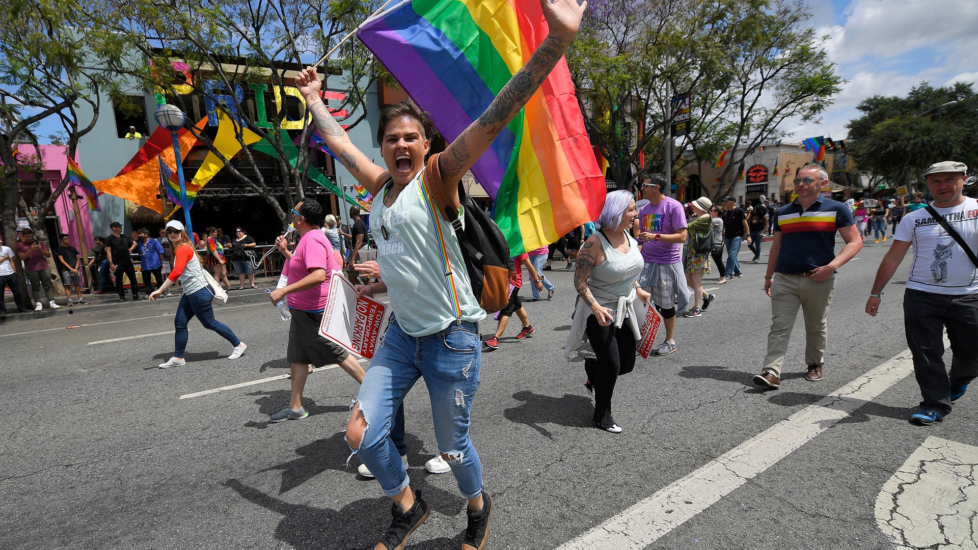 A marcher mugs for the camera during the Los Angeles LGBTQ #ResistMarch, in West Hollywood, California
