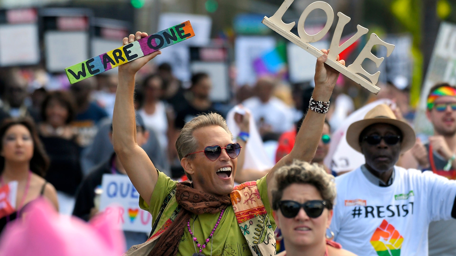 Marchers celebrate during the Los Angeles LGBTQ #ResistMarch, in West Hollywood, California
