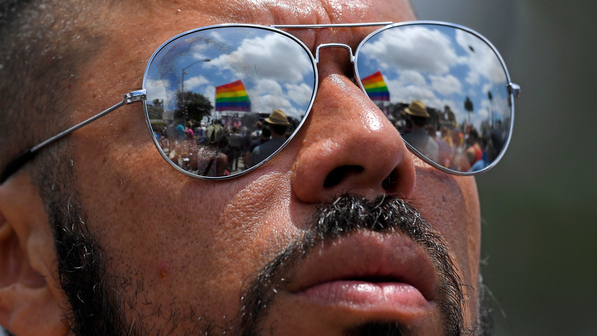 Edward Gonzalez listens to speakers at the end of the Los Angeles LGBTQ #ResistMarch, in West Hollywood, California