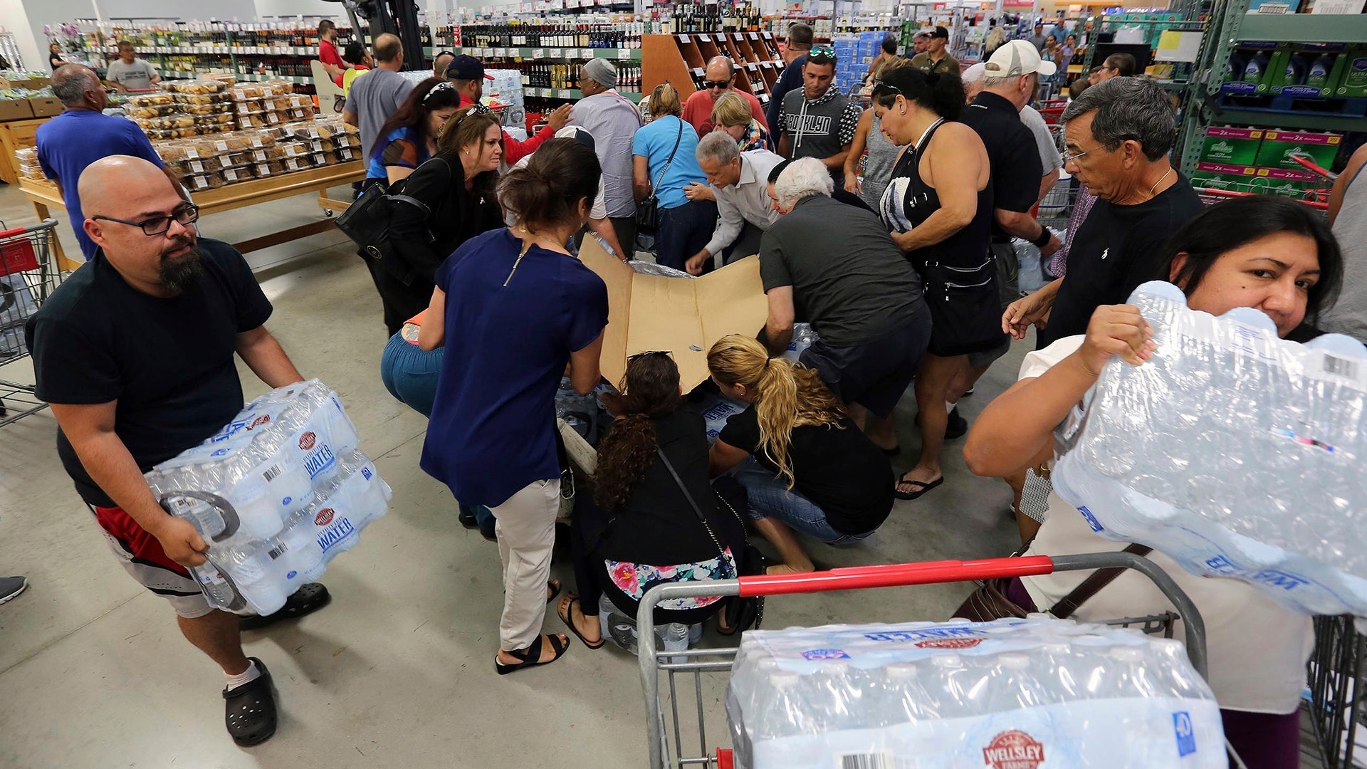 Residents purchase water at BJ Wholesale in preparation for Hurricane Irma, in Miami, Tuesday
