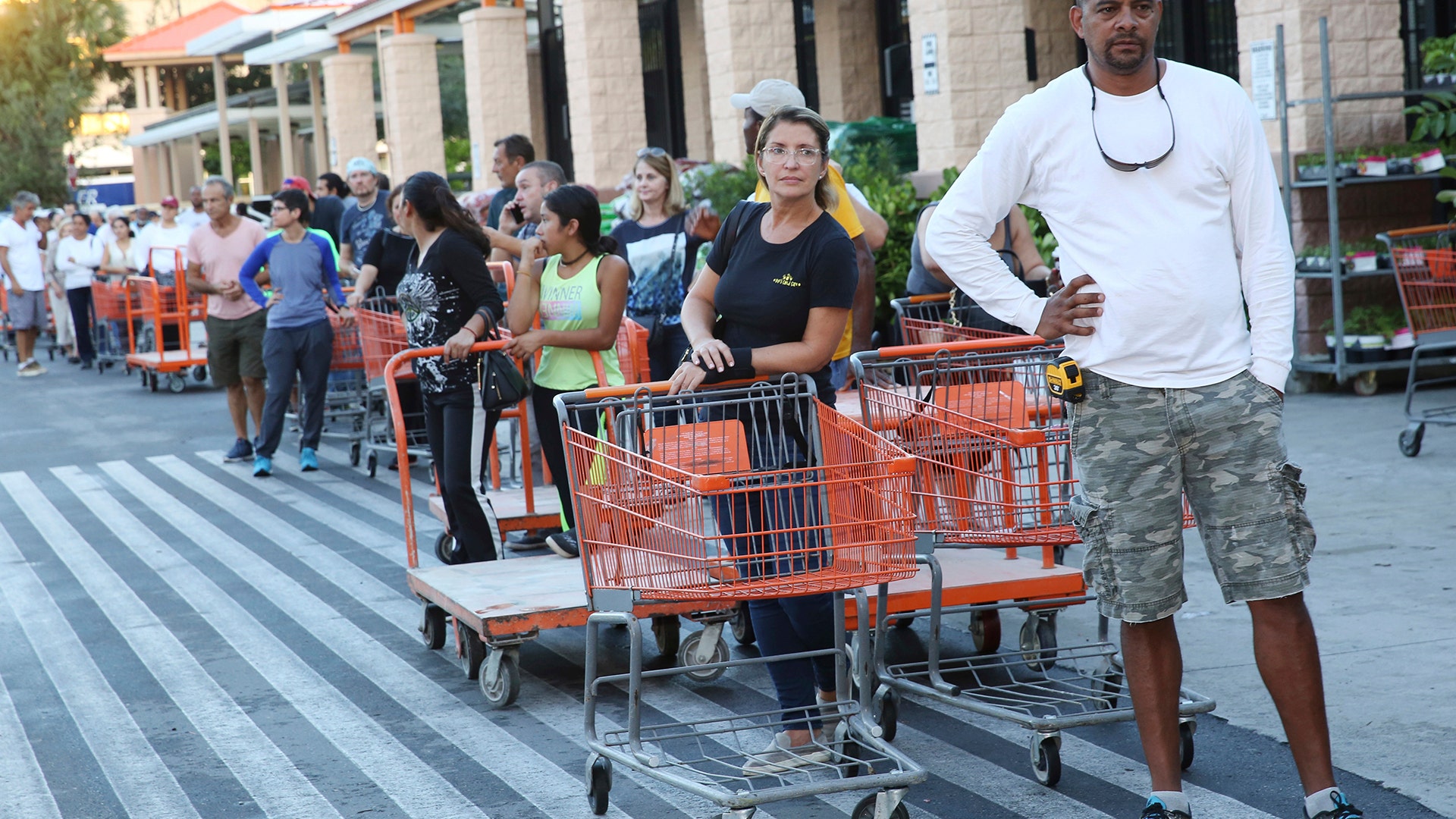 Eduardo Soriano of Miami, waits in a line since dawn to purchase plywood sheets at a Home Depot store in North Miami, Fla., Wednesday