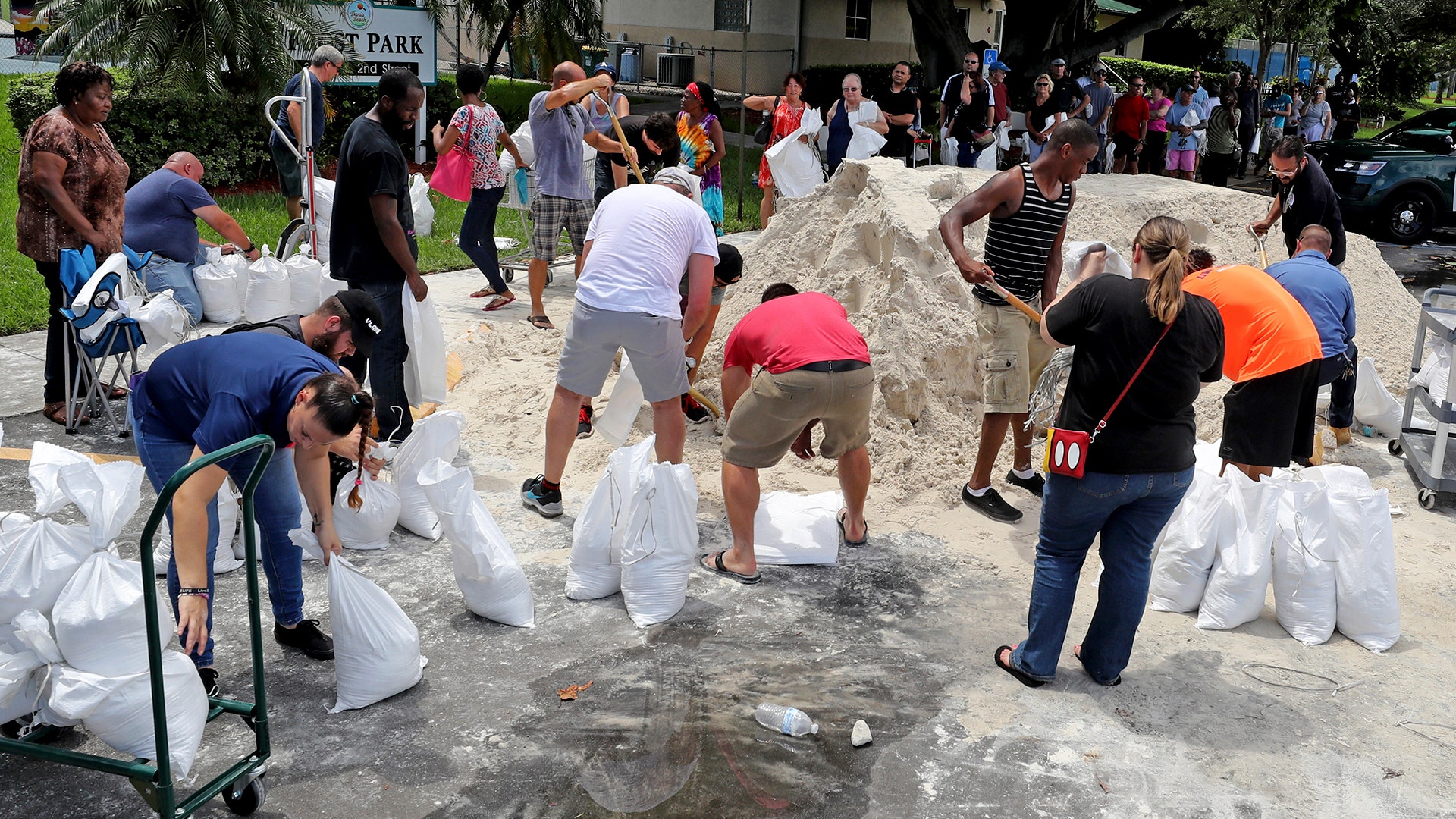 Residents line up to fill up sandbags in preparation of Hurricane Irma, in Frost Park in Dania Beach, Fla., Thursday