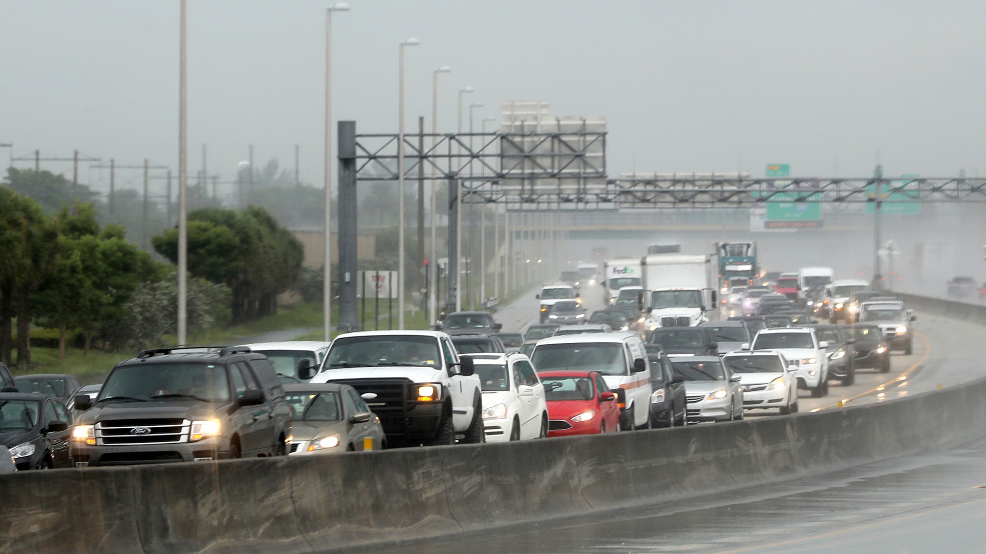 Northbound traffic on the turnpike backs up in the rain as motorist prepare for Hurricane Irma in Sunrise, Fla., Thursday