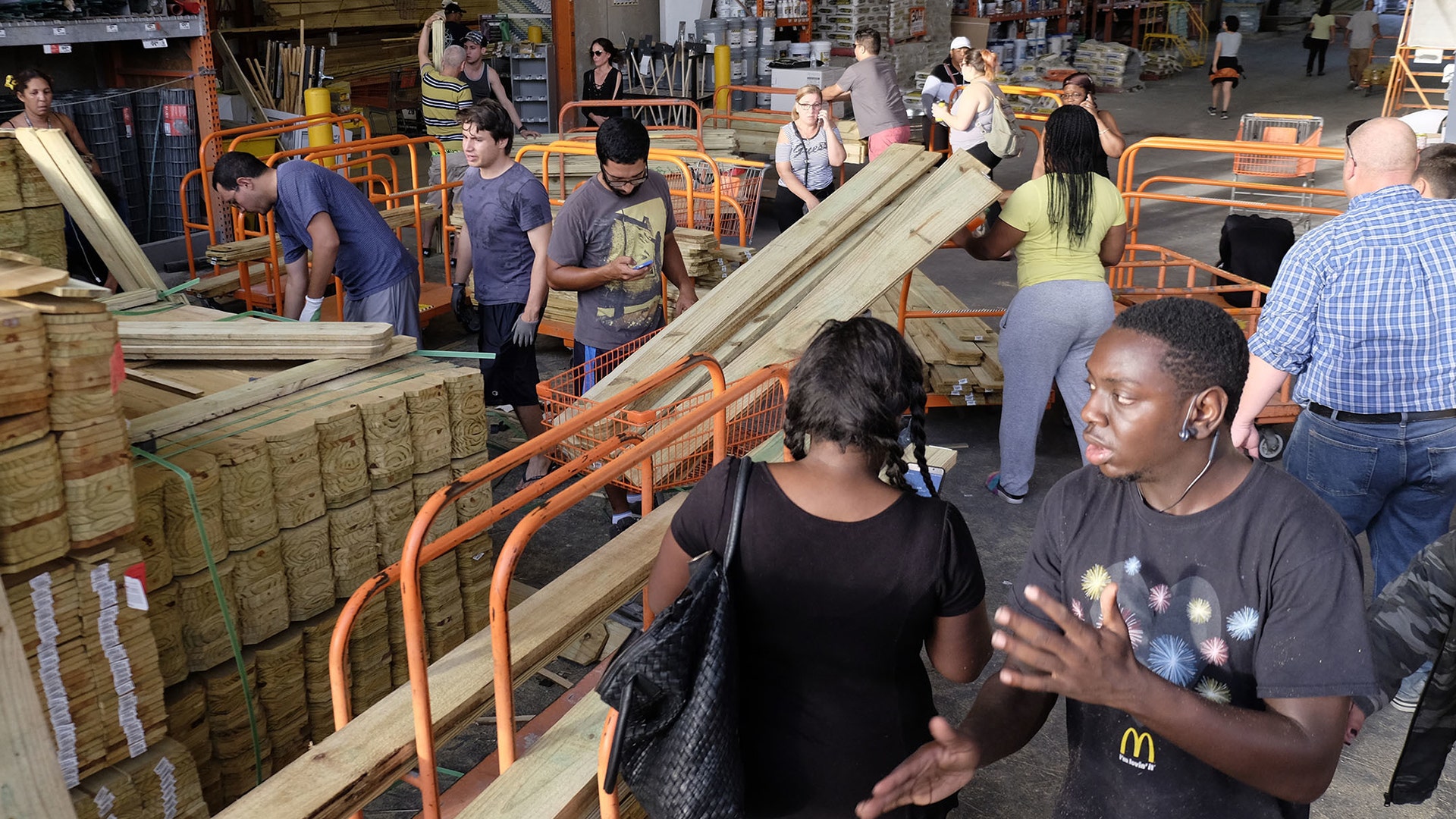 Customers at a Home Depot buy wood to secure their property in anticipation of Hurricane Irma early Friday