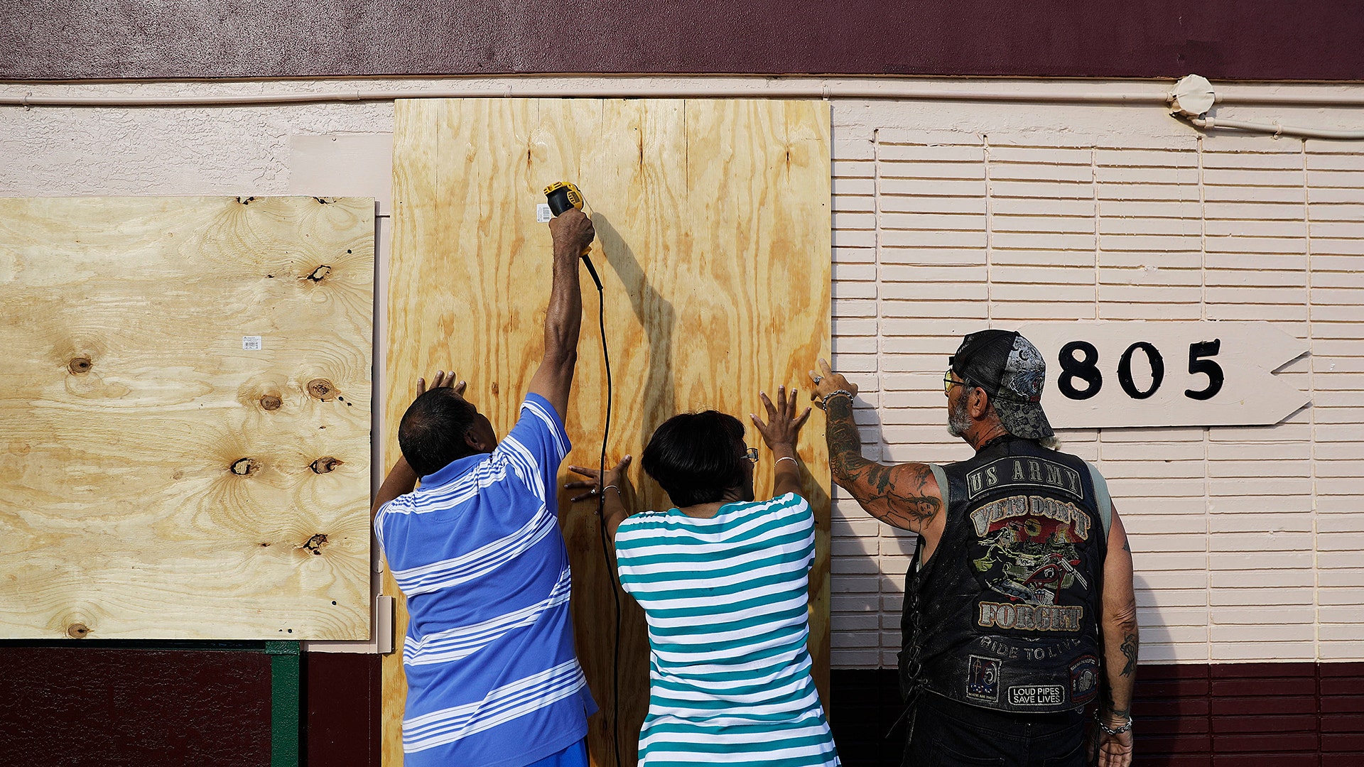  People board up a motel ahead of Hurricane Irma in Daytona Beach, Fla., Friday
