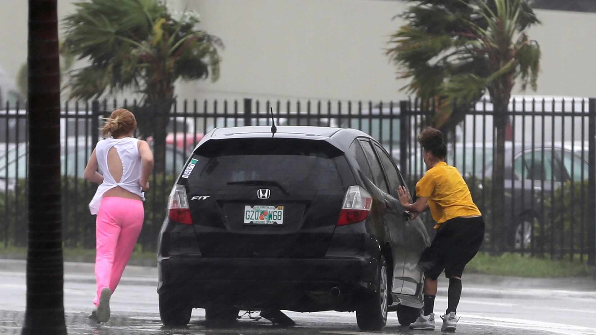 Stranded motorists try to get back in their car after a breakdown as Hurricane Irma bears down in Hialeah, Fla., Sunday
