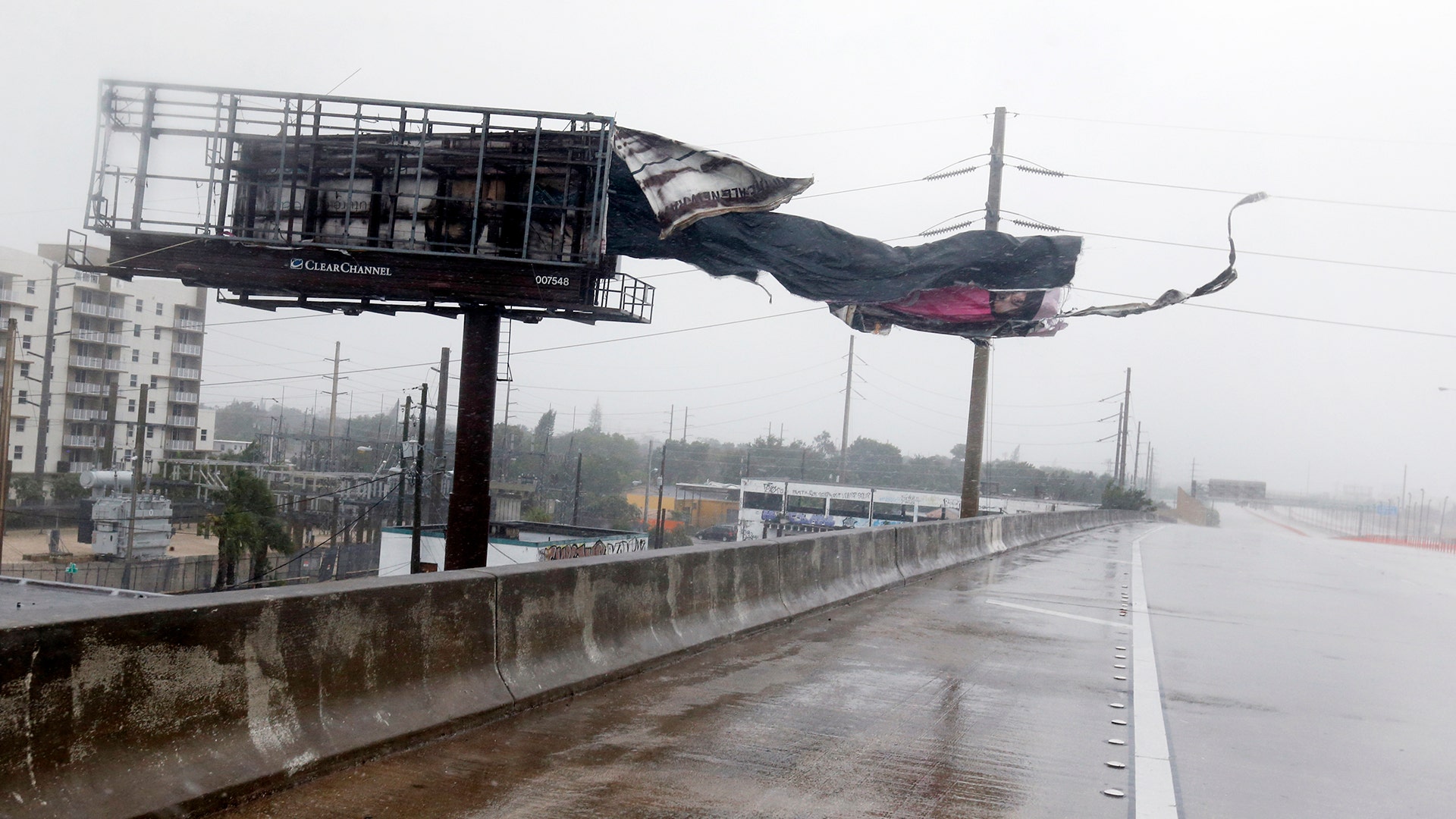 A billboard is ripped apart by high winds along Interstate 95 Northbound as Hurricane Irma passes by, Sunday