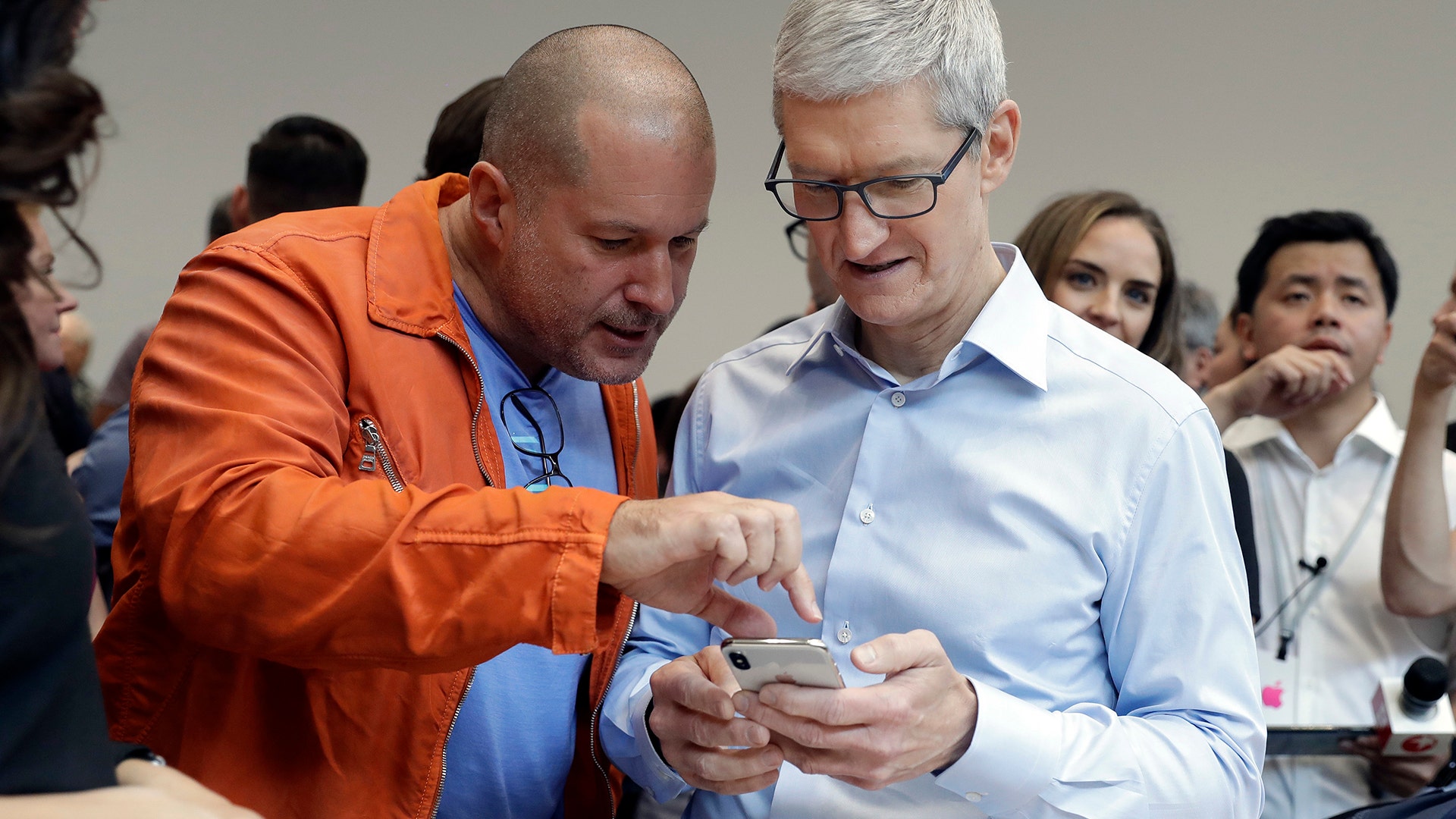 Apple CEO Tim Cook and Jonathan Ive, Chief Design Officer show the new iPhone X in the showroom Tuesday, in Cupertino