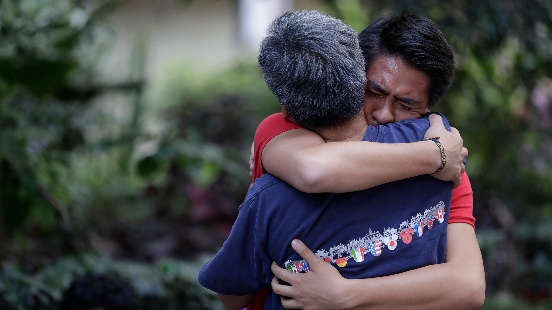 Men hug, crying with joy, as they reunite hours after an earthquake in the Condesa neighborhood of Mexico City, Tuesday