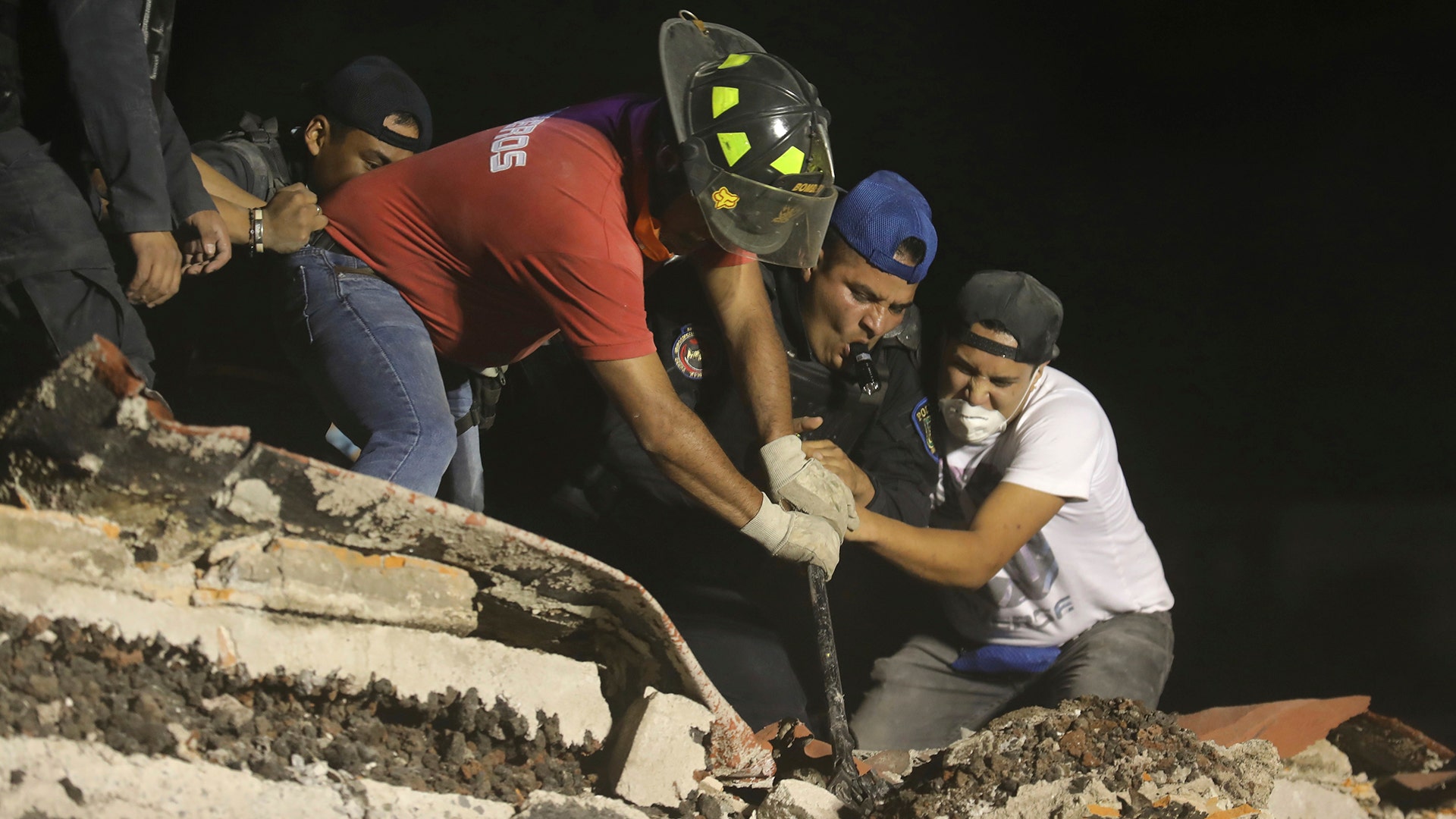 Rescue workers search a building that collapsed after an earthquake, in the Colonia Obrera neighborhood of Mexico City, Tuesday