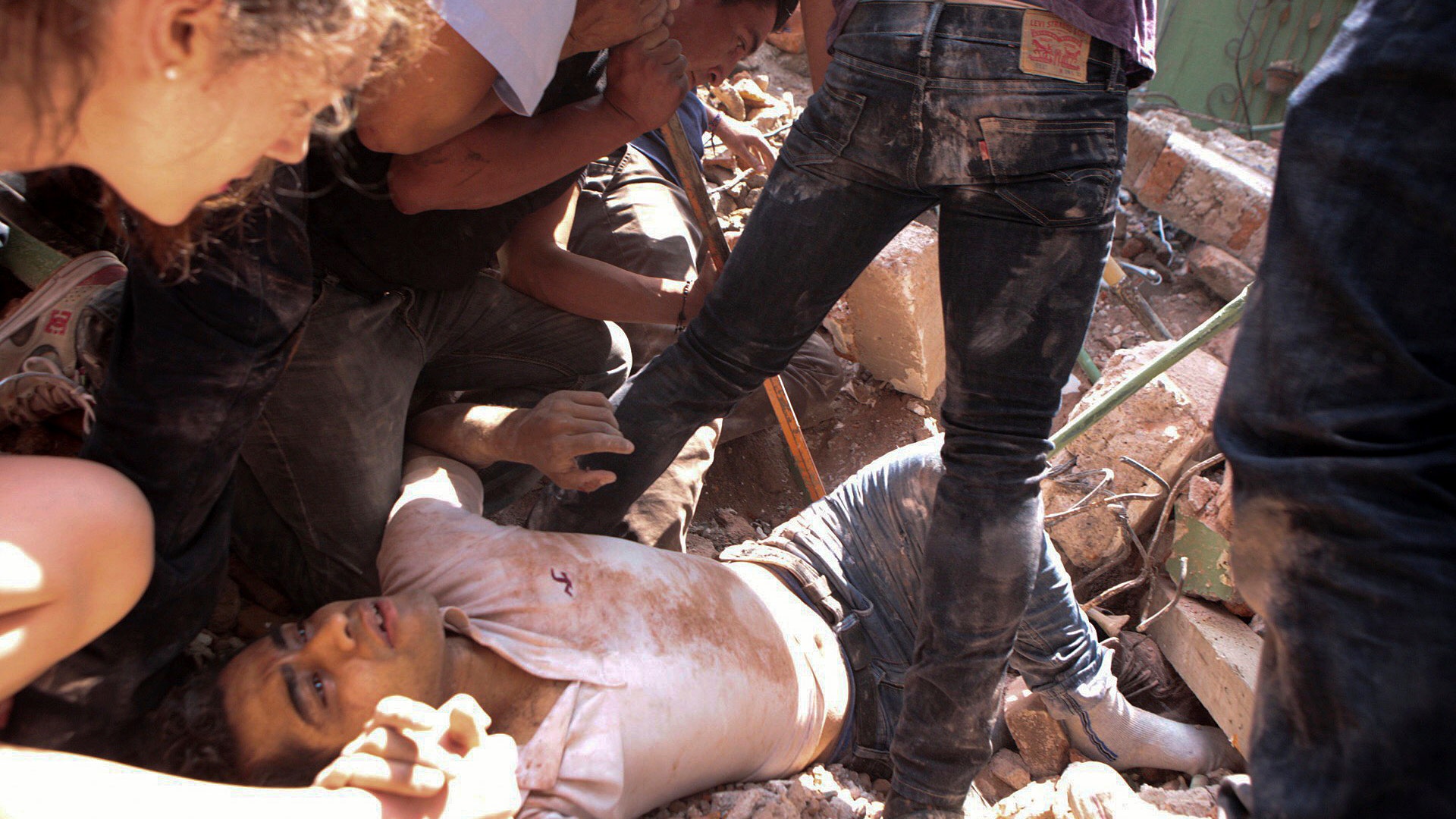 A man is rescued from a collapsed building in the Condesa neighborhood of Mexico City after an earthquake in Mexico, Tuesday