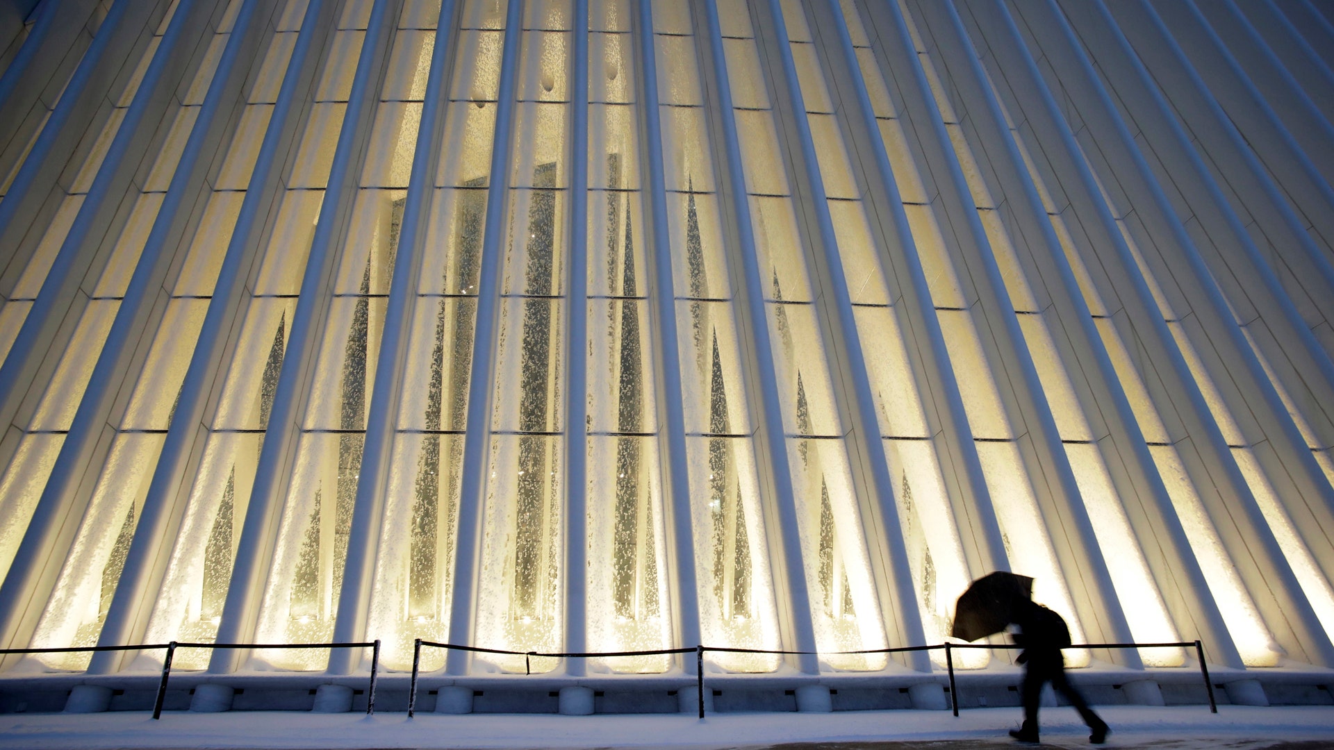 A man makes his way through wind and snow past the Oculus of the World Trade Center Transportation Hub, Thursday, Feb. 9, 2017, in New York. 