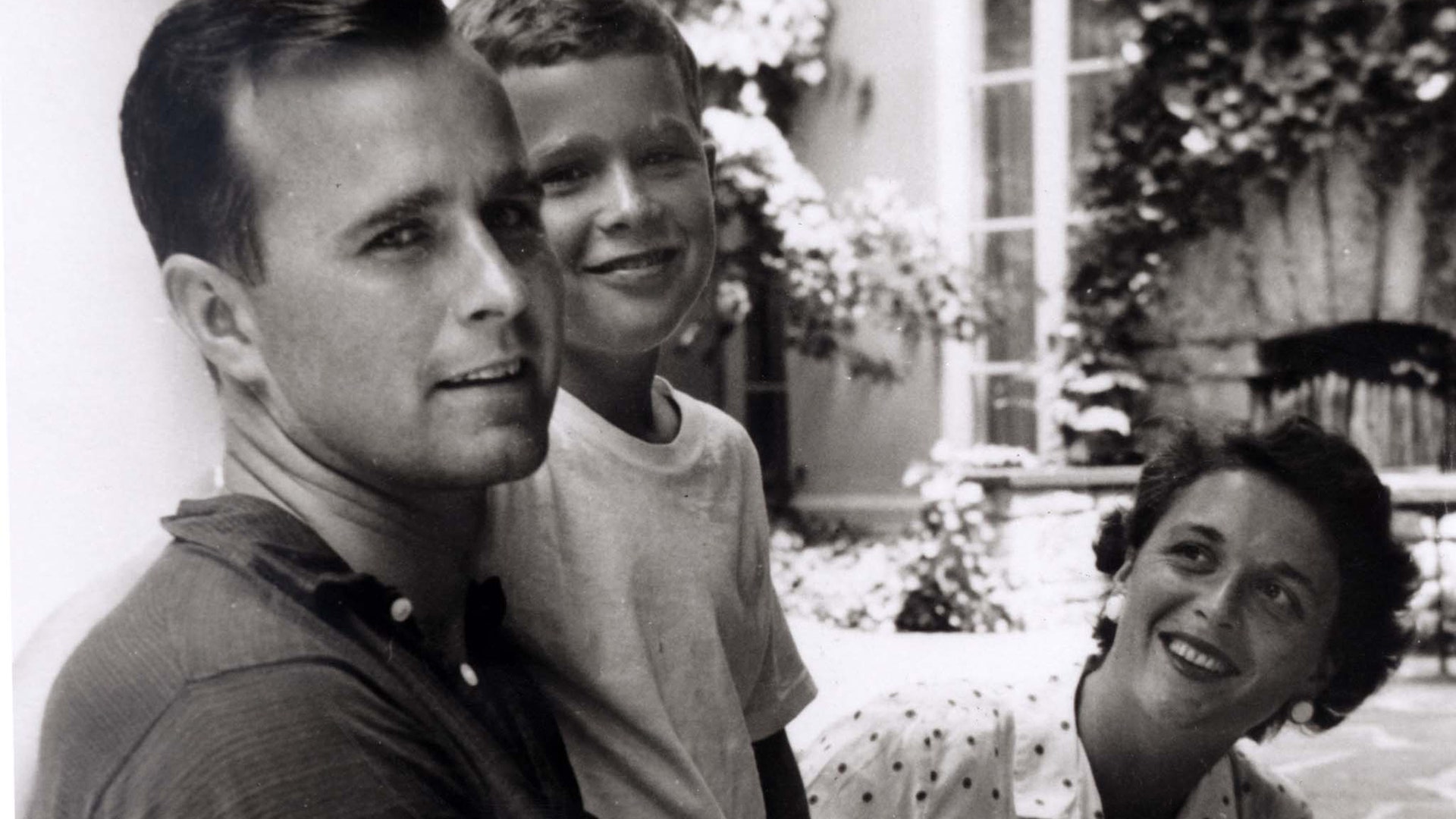 George W. Bush is shown with his father, future President George Bush and mother, future first lady Barbara Bush