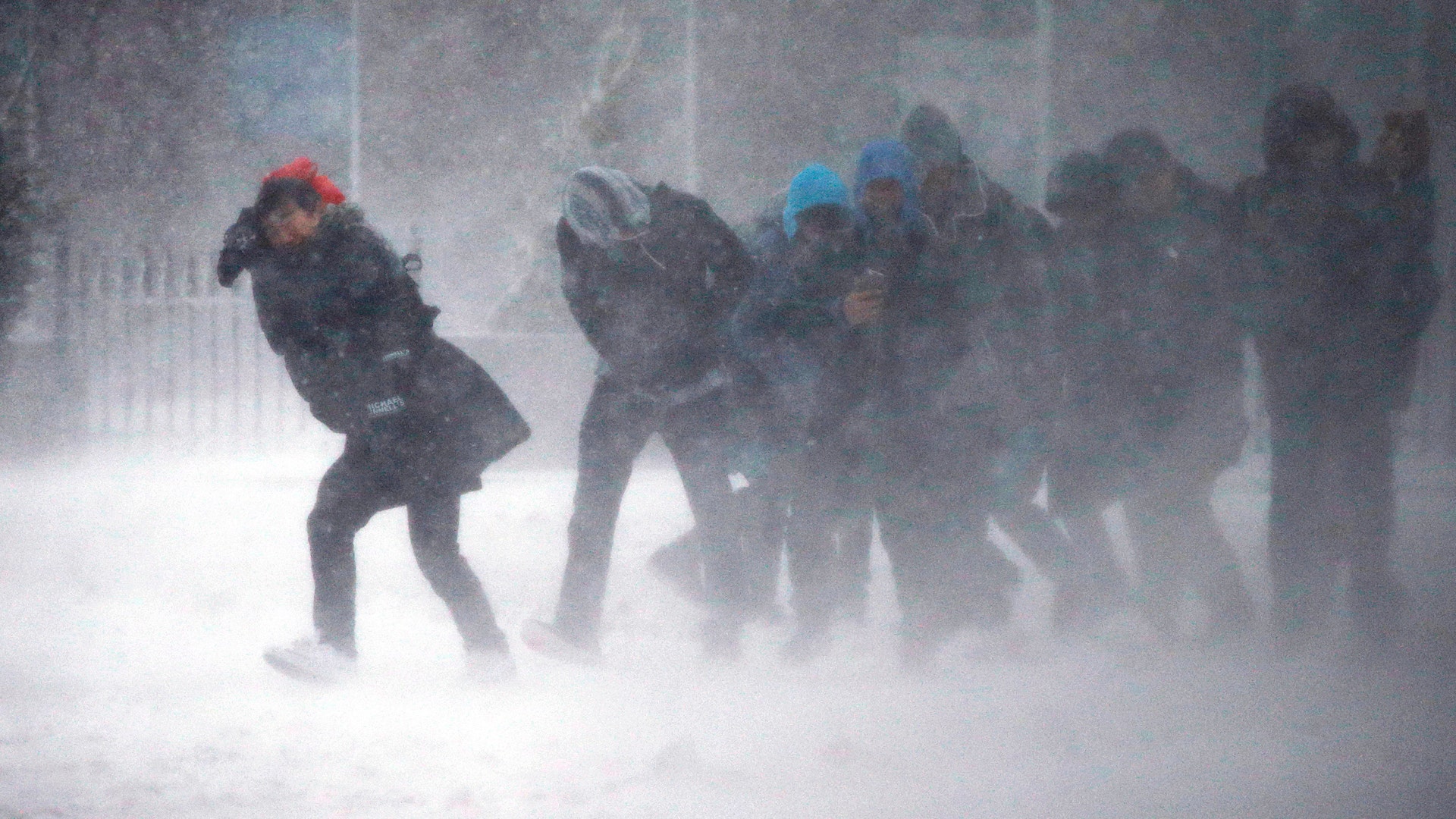People struggle to walk in the blowing snow during a the storm Tuesday, March 14, 2017, in Boston.