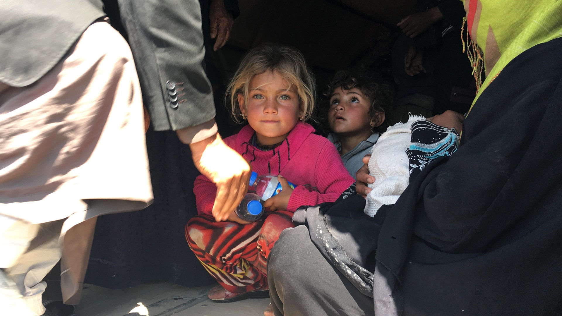 IDPs are loaded into a truck after a midnight escape from ISIS in Badush, Iraq, April 2017