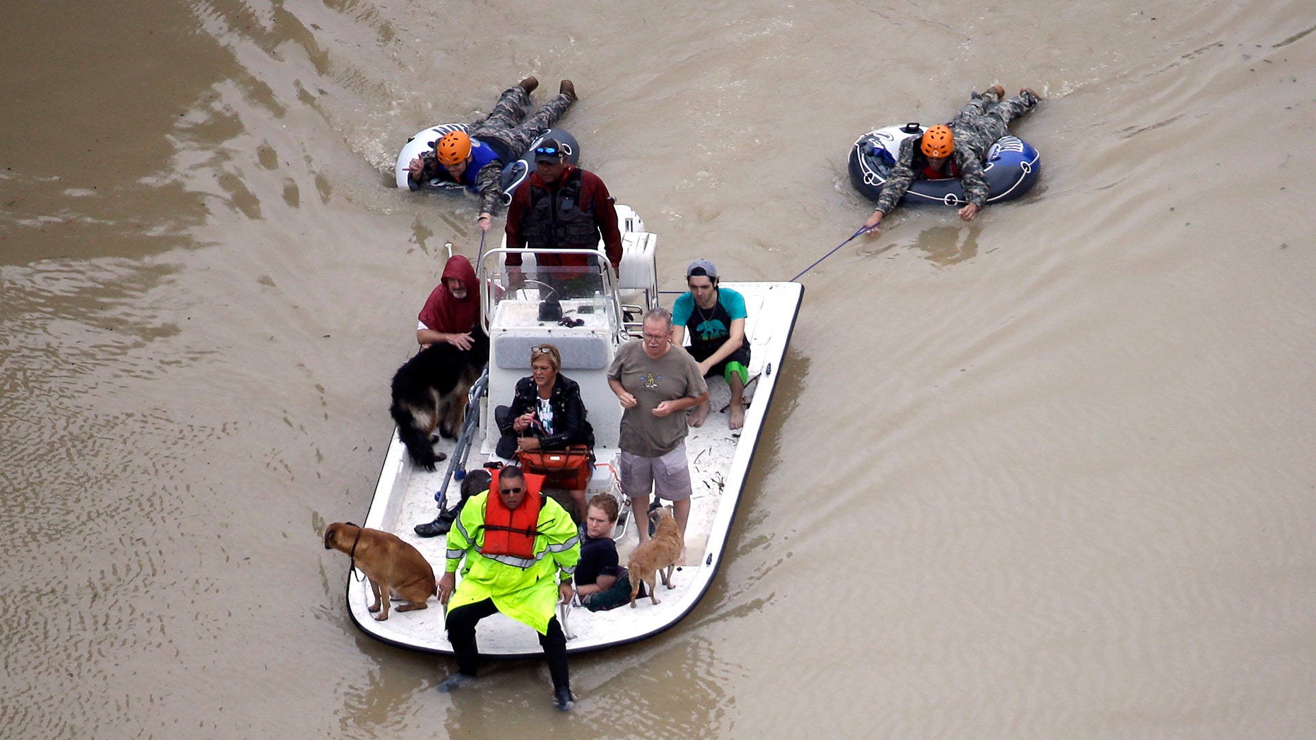 Evacuees make their way though floodwaters near the Addicks Reservoir as floodwaters from Tropical Storm Harvey rise Tuesday, in Houston