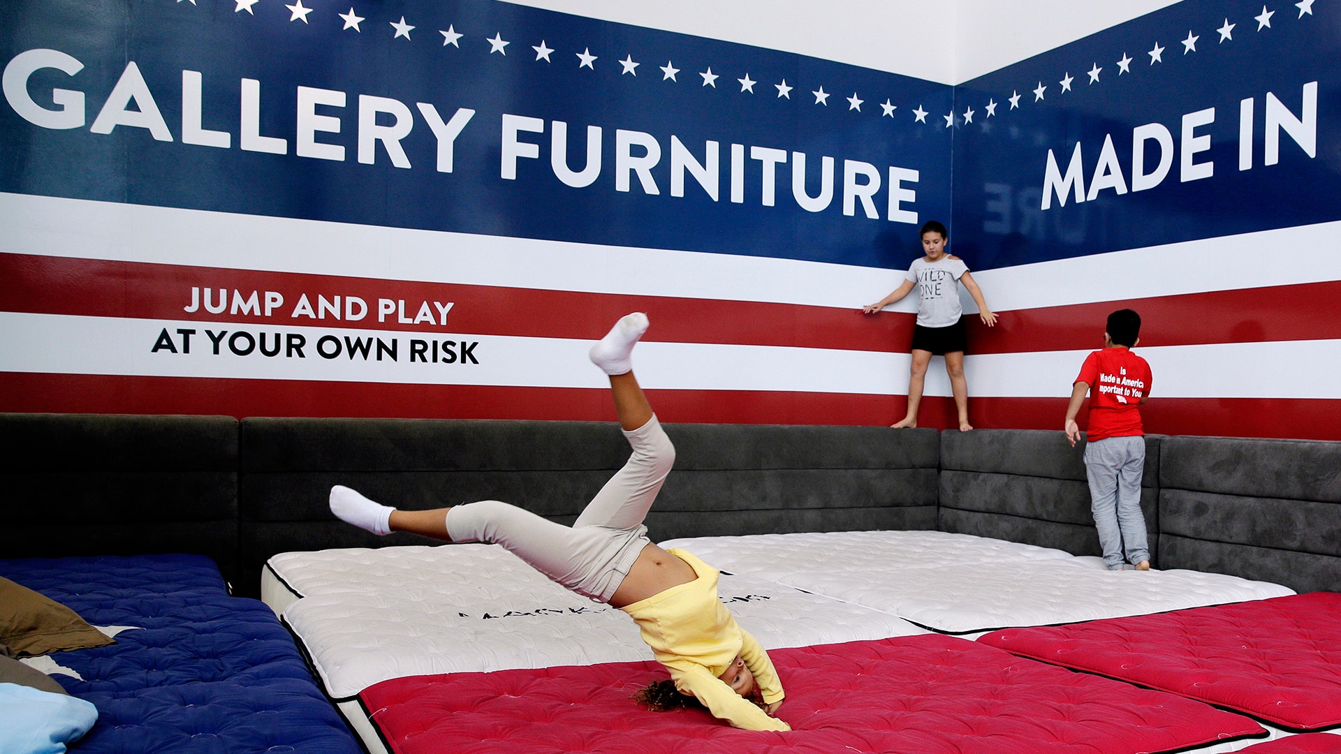 Displaced kids play while sheltering at Gallery Furniture, Wednesday, in Richmond, Texas
